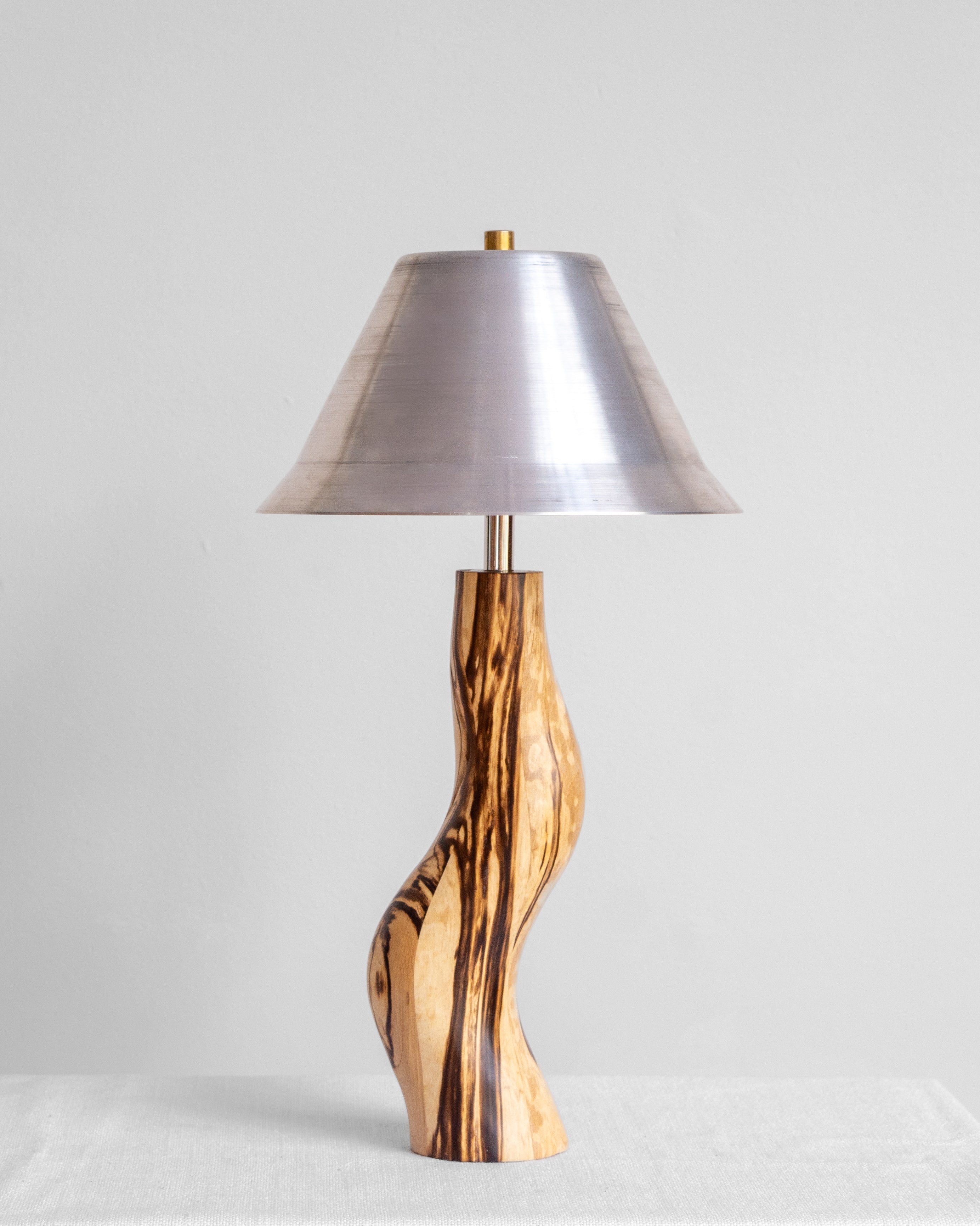Dancing Desk Lamp with Spalted timber base and Aluminium shade on a light grey background with UK, EU and US/CA wiring available Wilkinson & Rivera