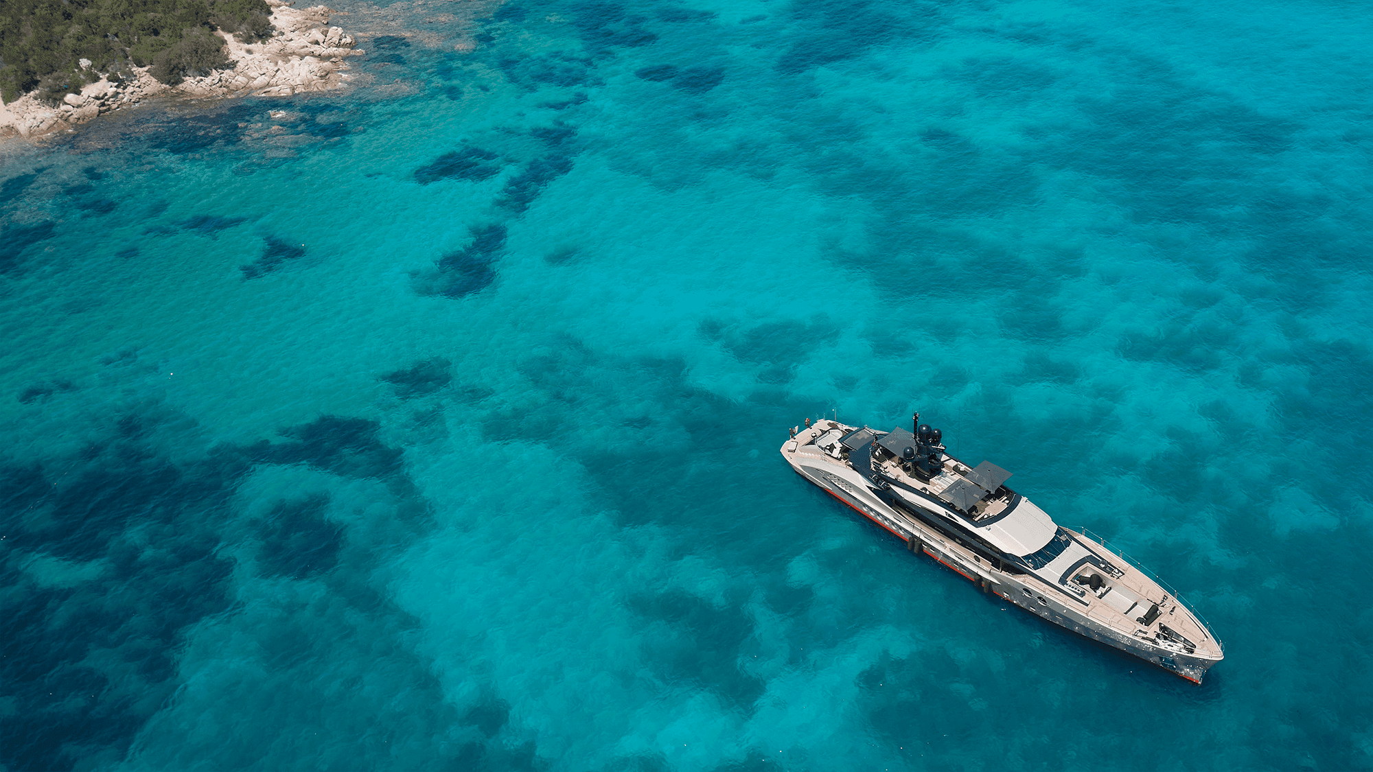 nfinity pool blending into the ocean view, minimalist sun loungers in soft neutral fabric, curved architecture