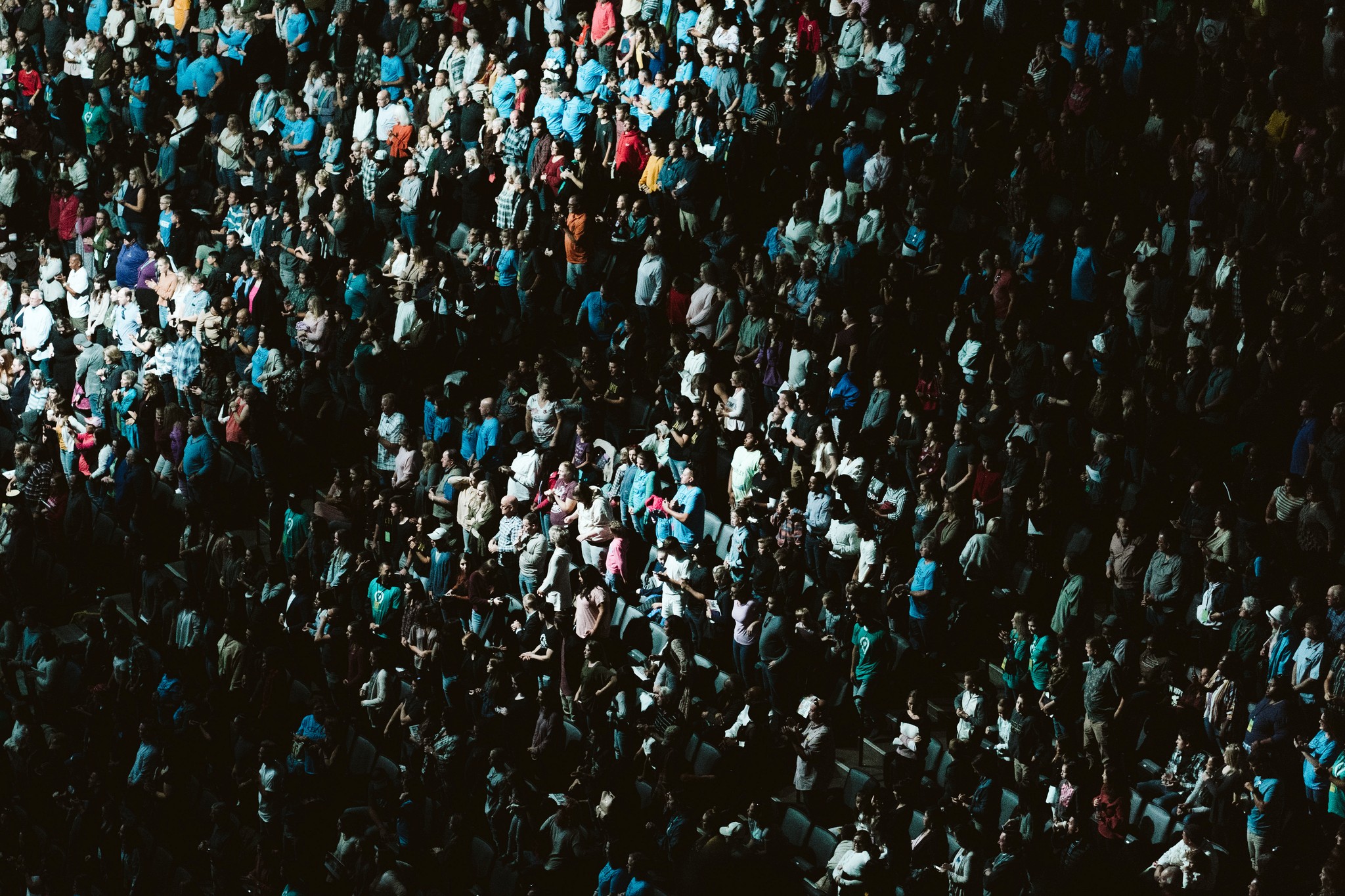 woman holding a phone and man looking at the phone. both are smiling