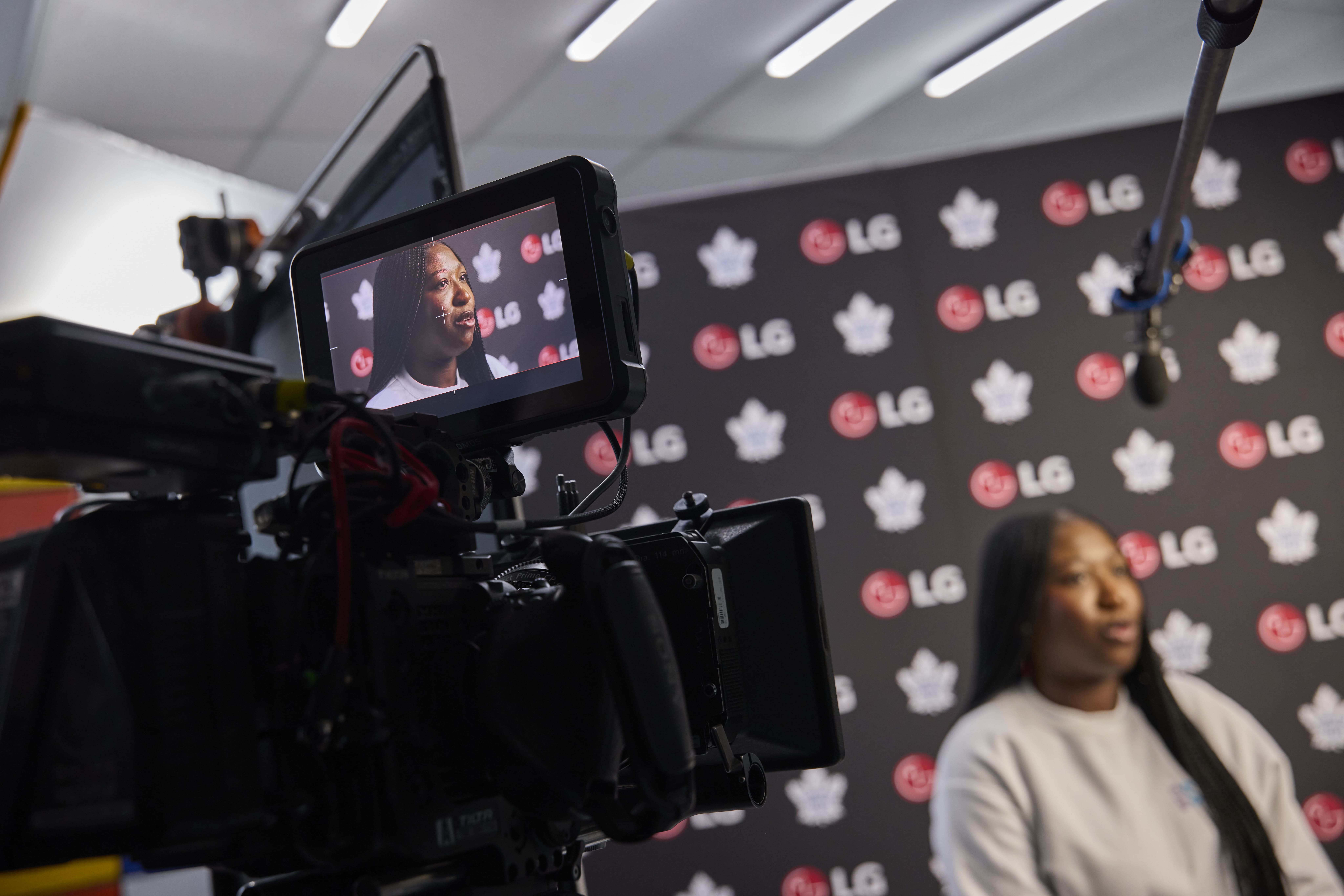 Film crew filming a person in a studio