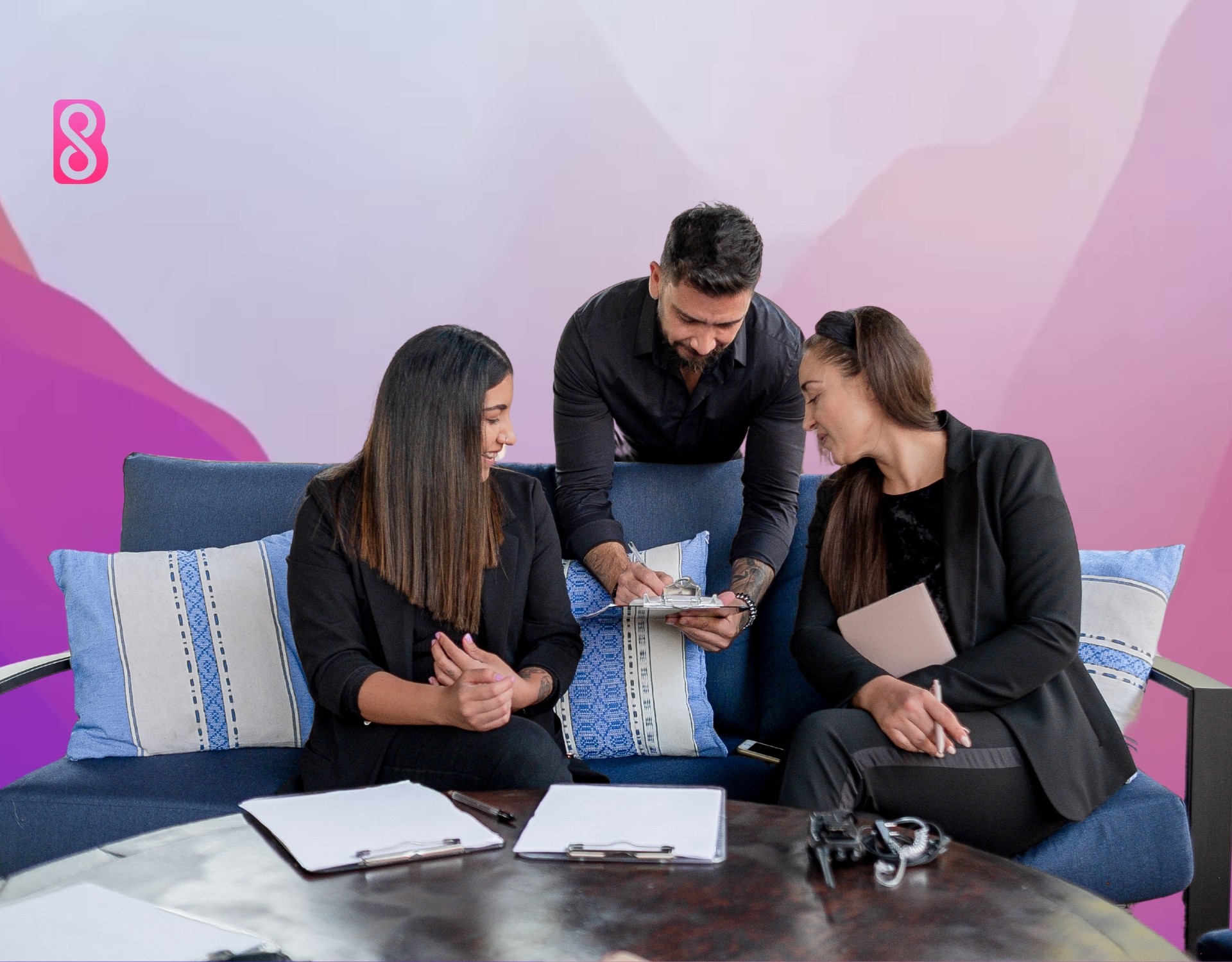 Group of Event Planners sitting on a sofa discussing about the event