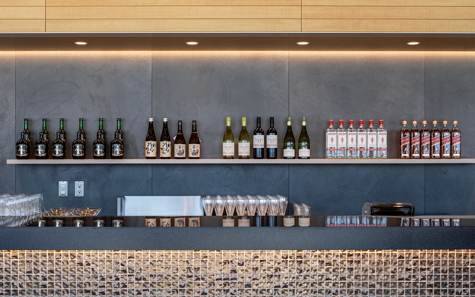 Bar counter with assorted bottles at Plaza Premium Lounge, Chubu Centrair International Airport.