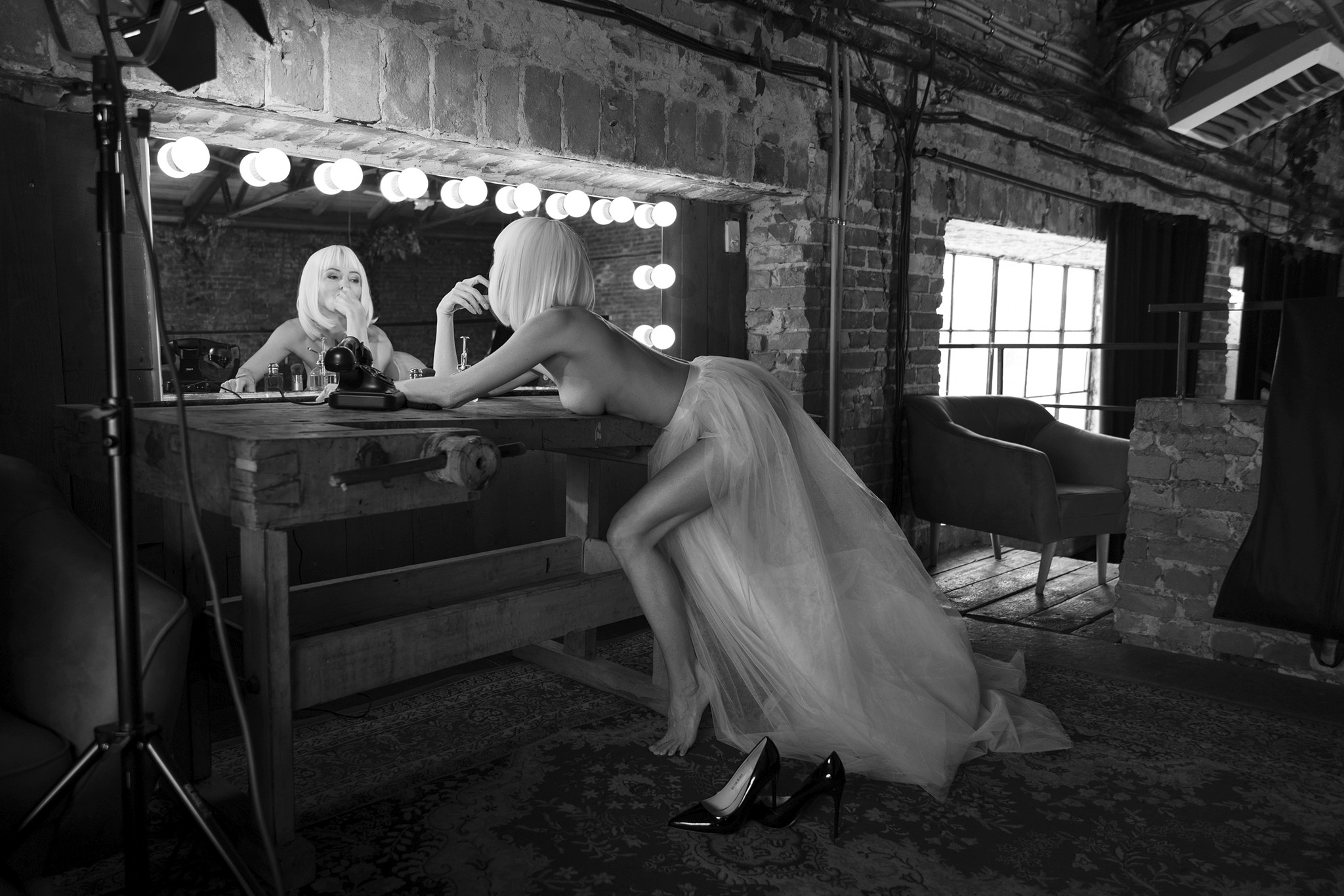 Woman in a white dress sitting at a vintage dressing table - The Space Between Roles - Agnieszka Czyzkowska Photography