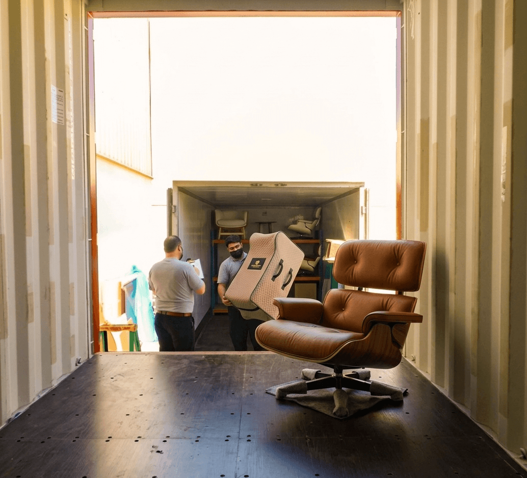 Team picking up furniture for packing and transport