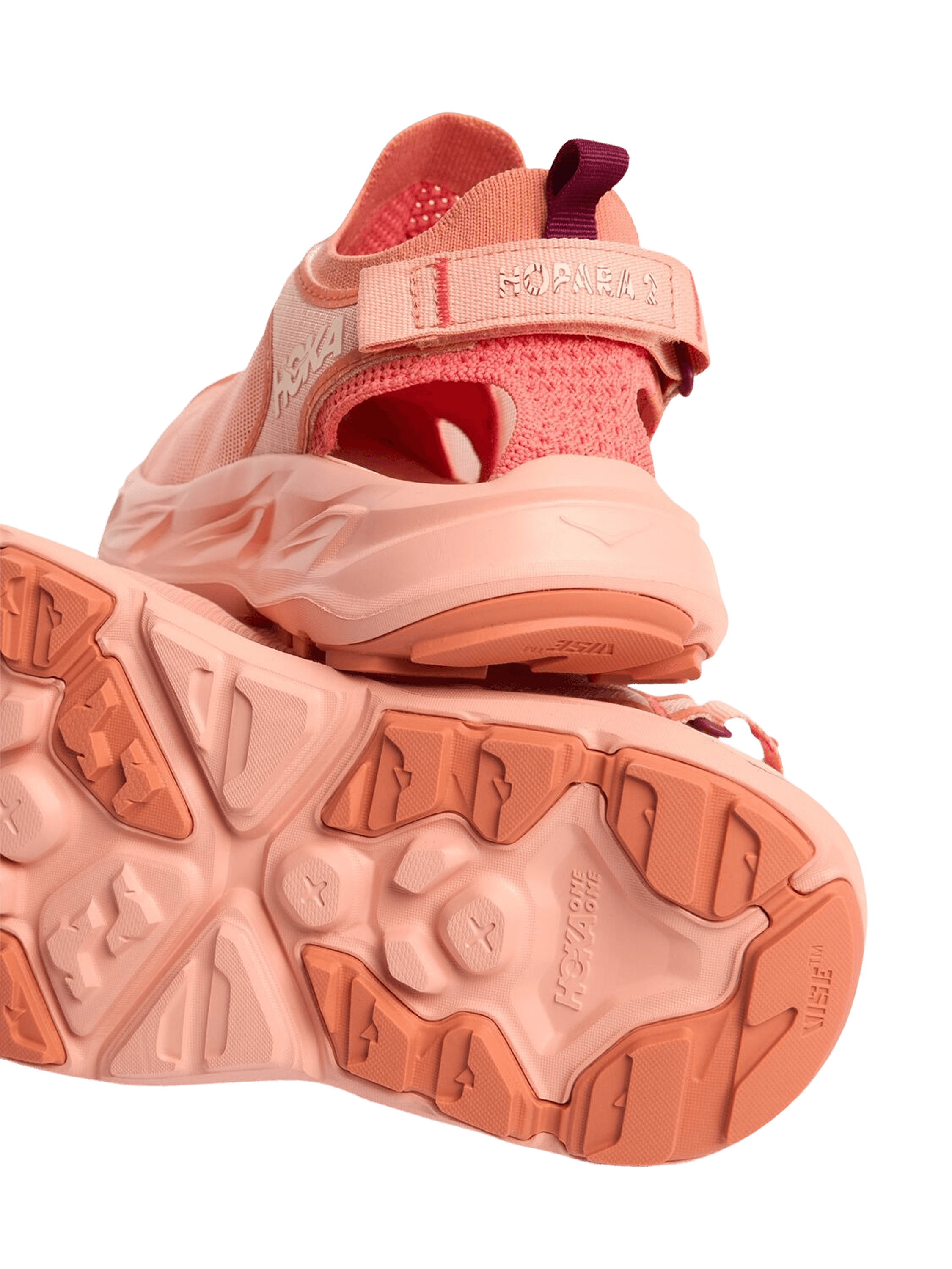 close up image of pink sneakers stacked upon themselves
