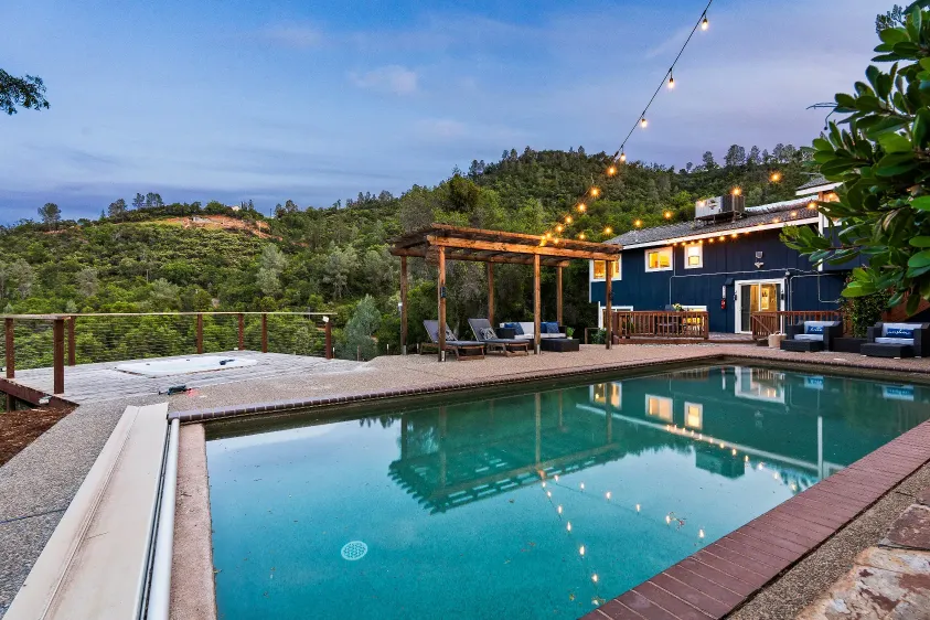 Poolside patio with string lights at dusk