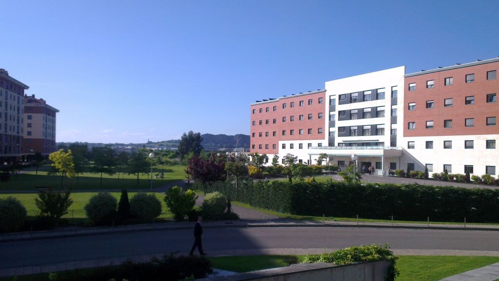 Exterior view of a multi-story residential complex with landscaped grounds.