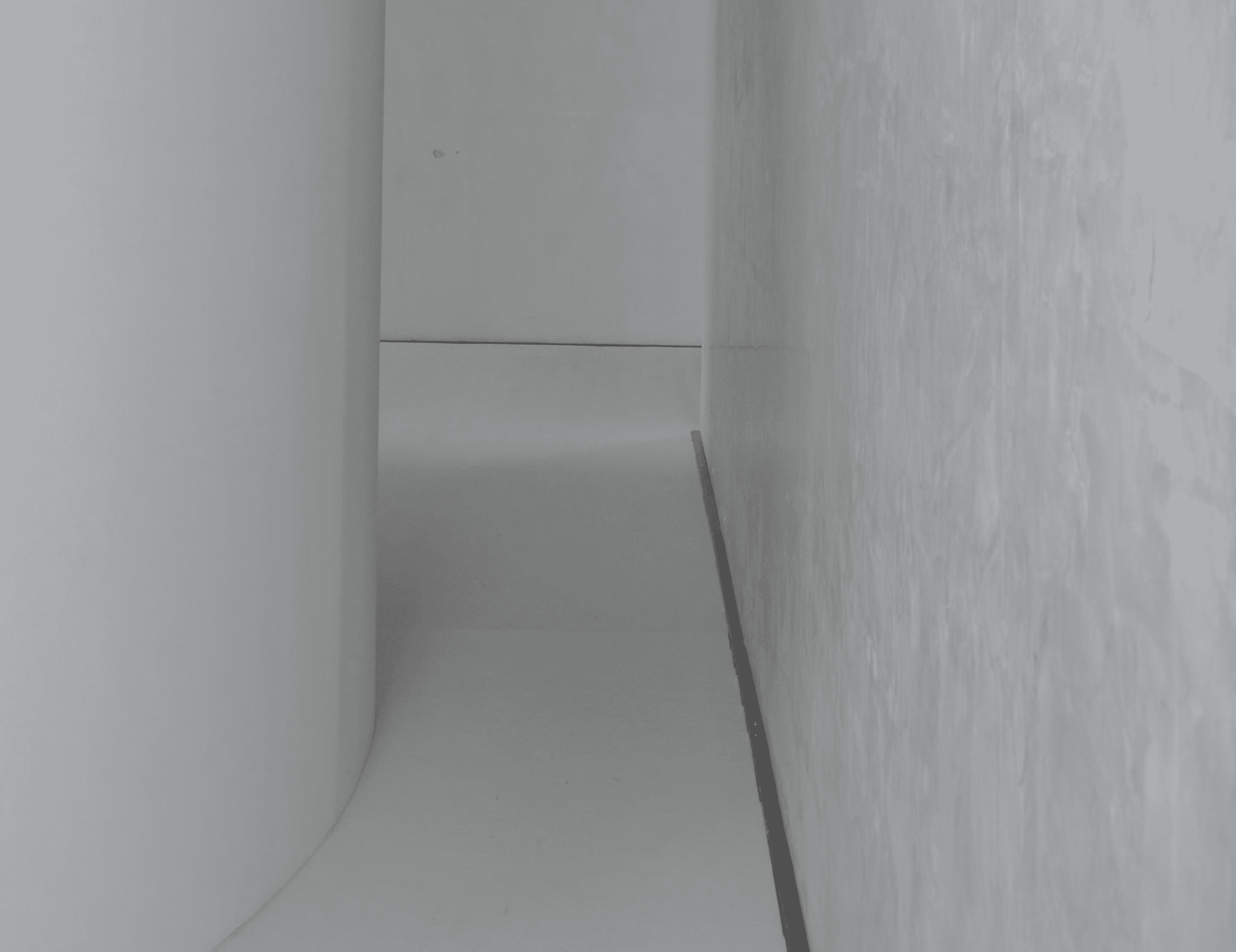 Minimalist architectural interior with soft light and shadow.