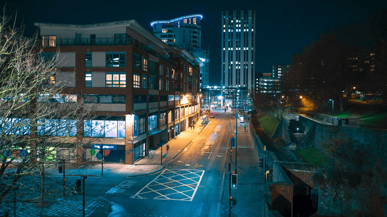 Young lady smiling while working through technical problem next to white board