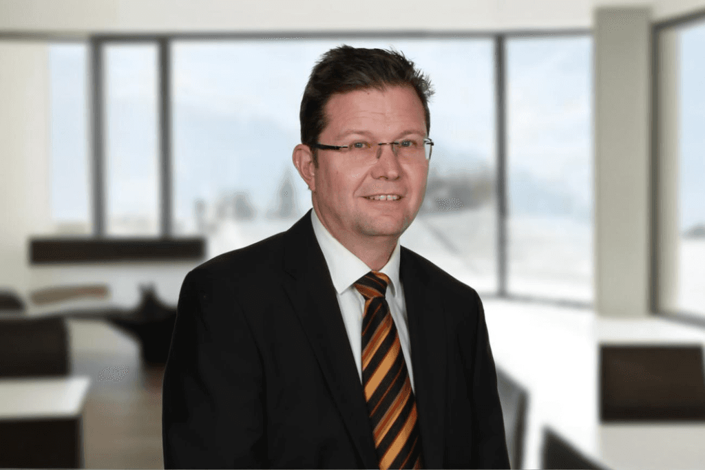 person in red and black plaid long sleeve shirt using black laptop computer