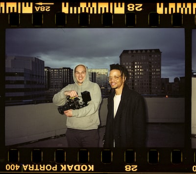 two videographers on a roof top in america