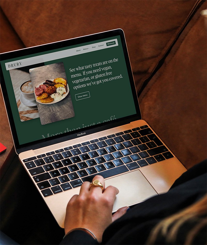 woman inside on her sofa viewing the lift and revive website on her phone