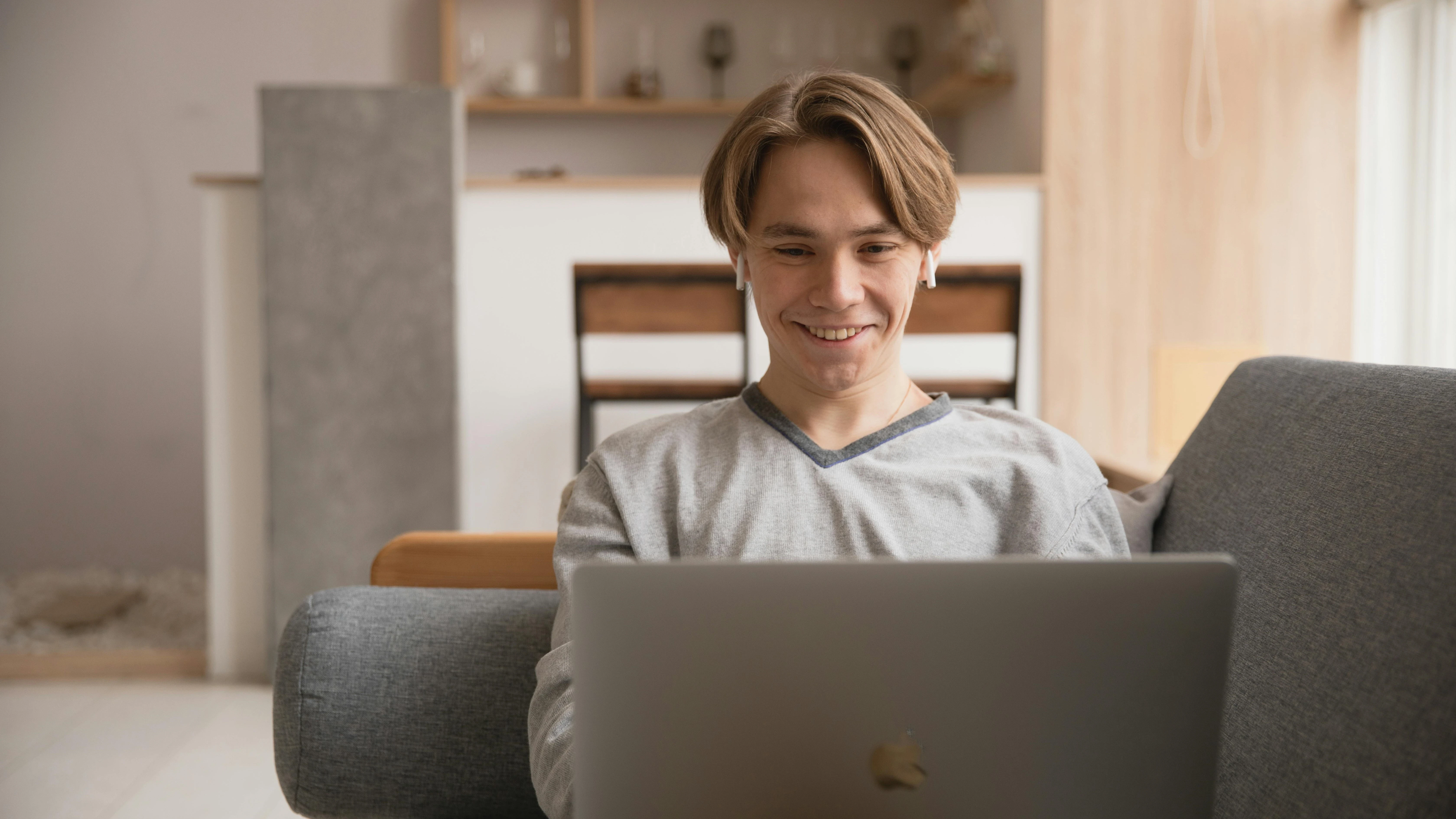 High school student attending RISE Research virtual summer program from home, engaging in online STEM learning and mentorship through a laptop.