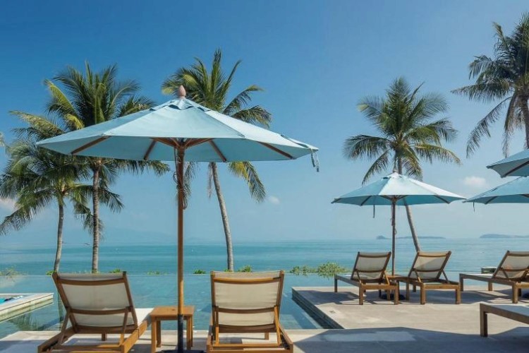 sunloungers fronting buildings near mountain