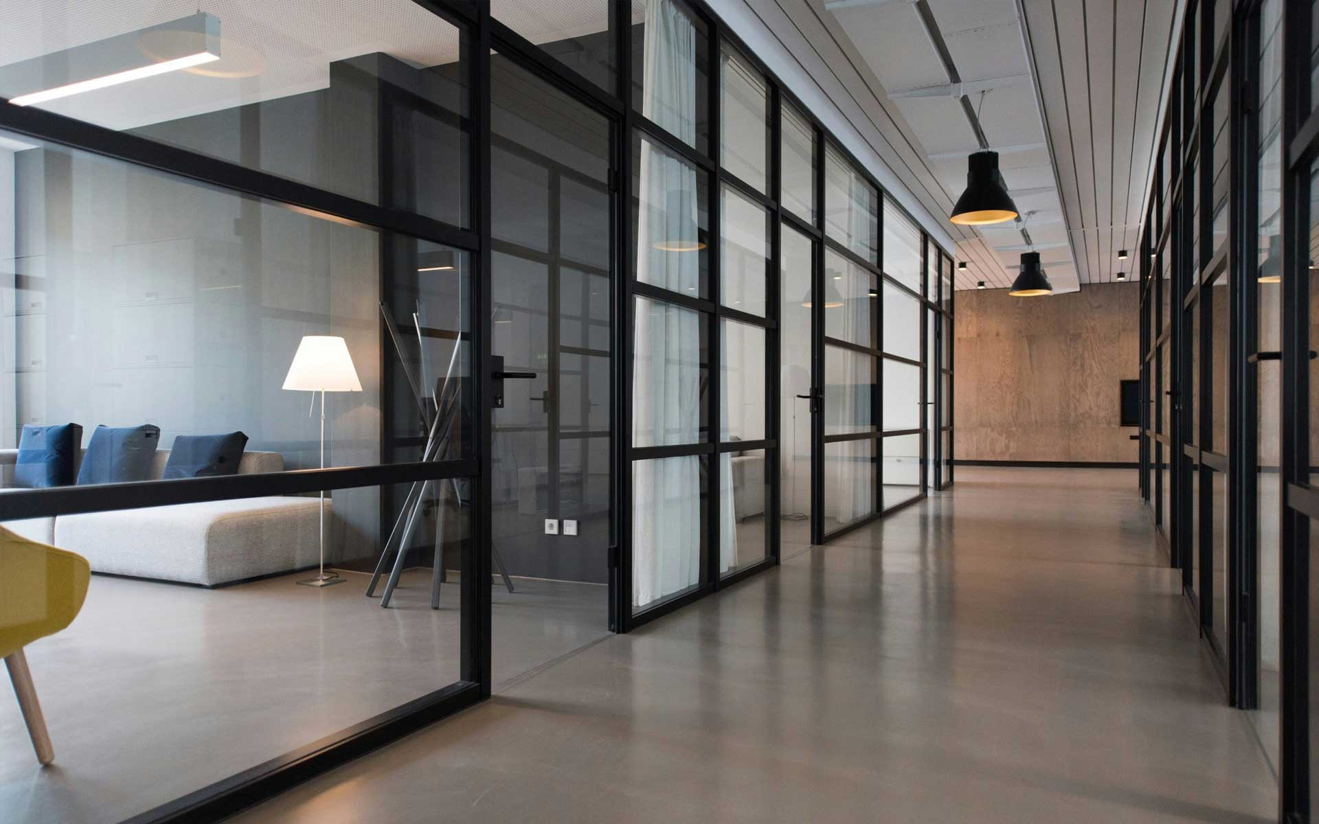 Office space with large glass window seperating offices