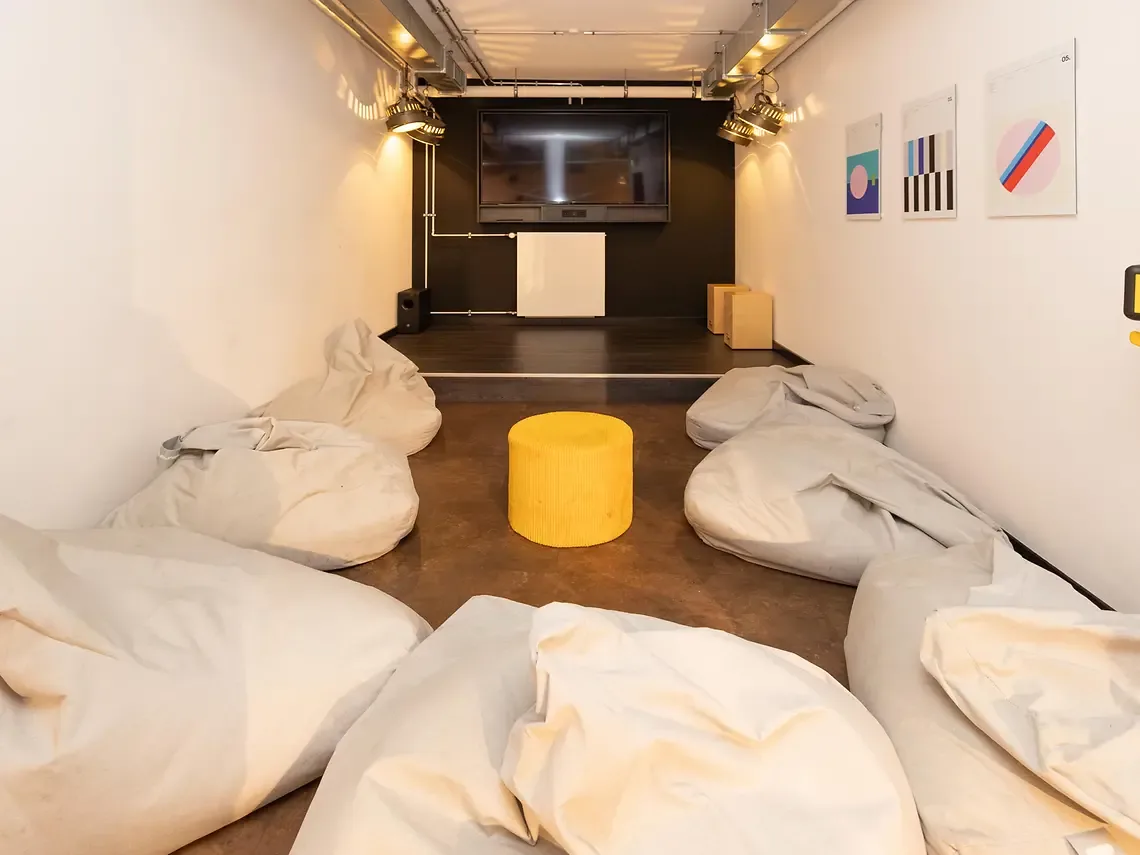 Cinema room in student accommodation in Hamburg with bean bag seating and large screen