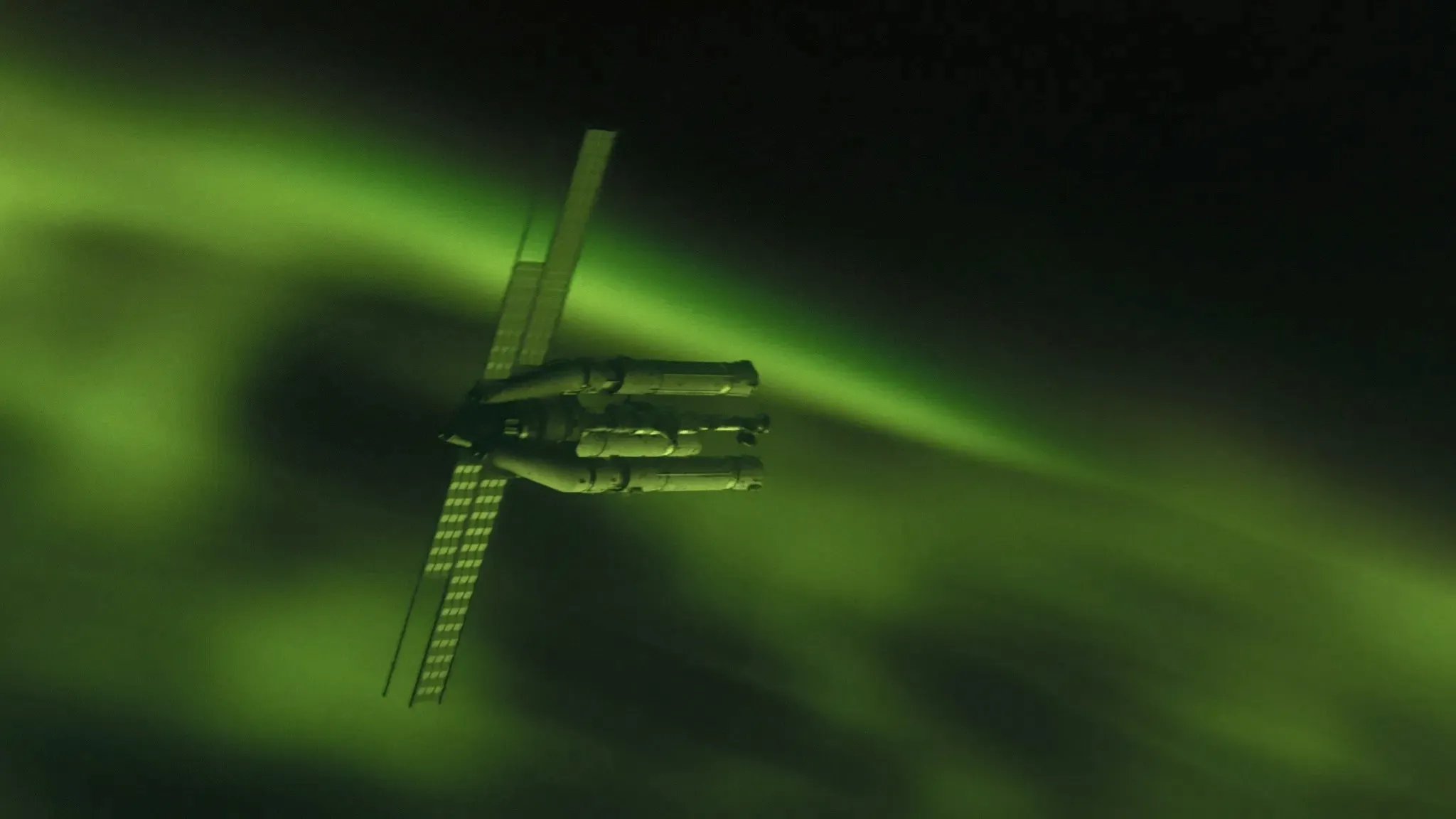 A long spaceship with extended solar panels orbits a misty green nebula against the vibrant, green backdrop of deep space.