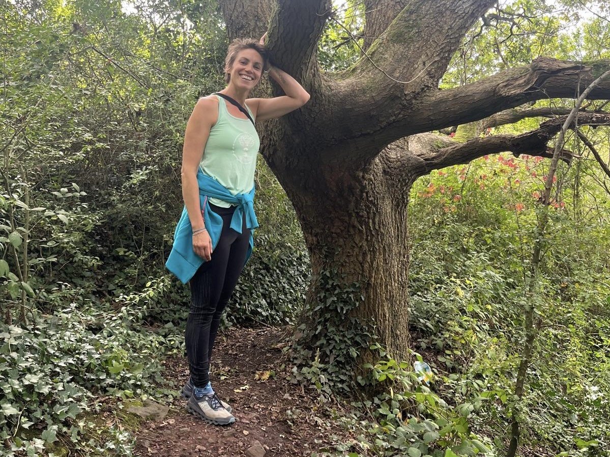 Leaning up against a favourite oak in her local woodland