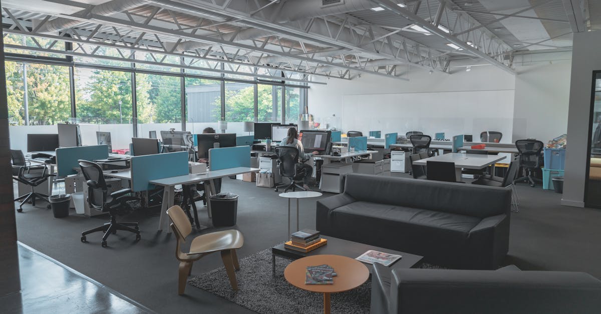 A spacious modern office with desks, computers, and natural light creating an inviting work environm