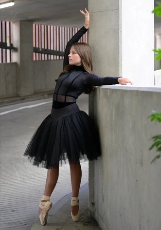 Ballerina posed against a wall