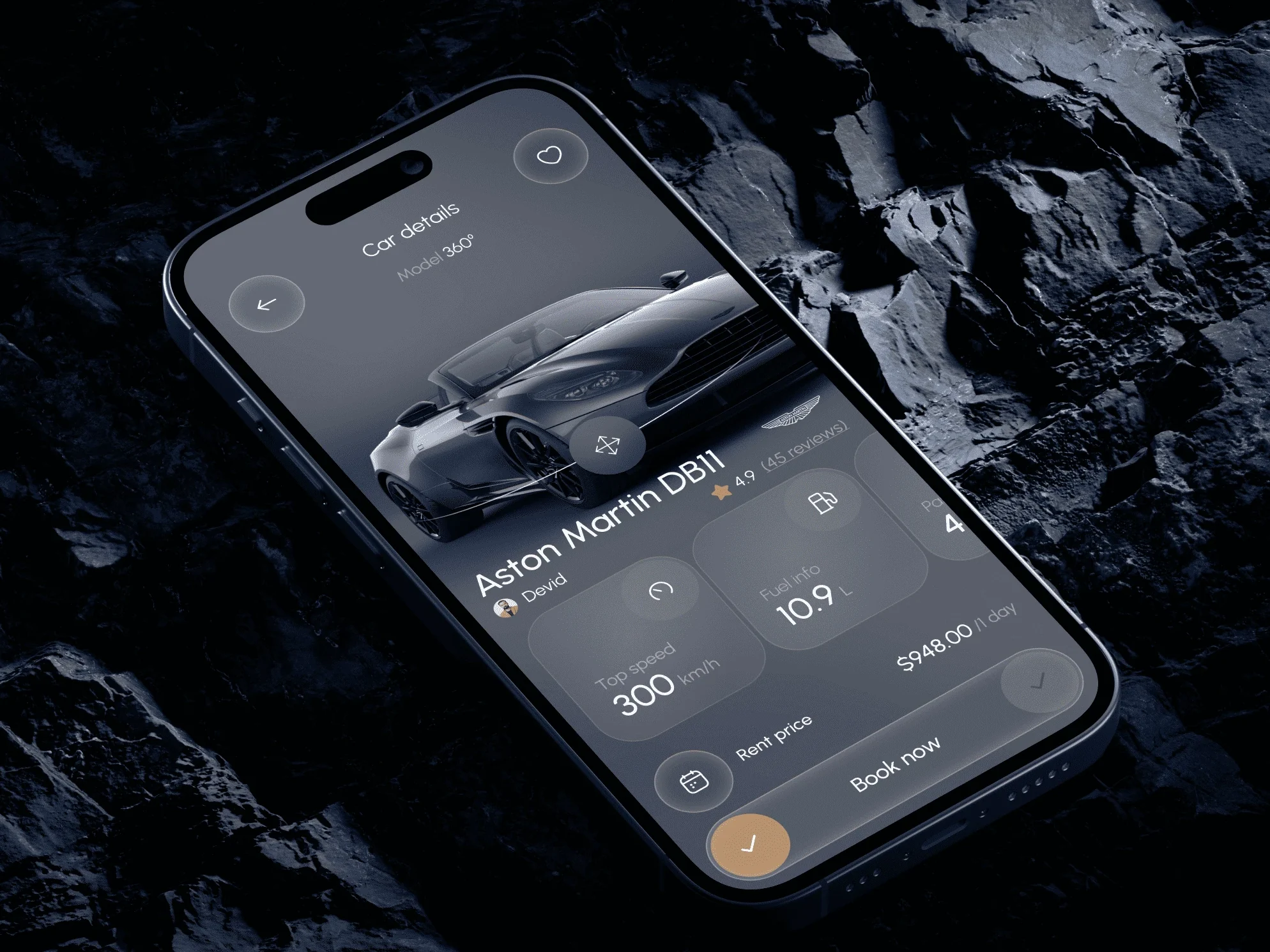 A car app on a phone showing an Aston Martin DB11, lying on dark rock