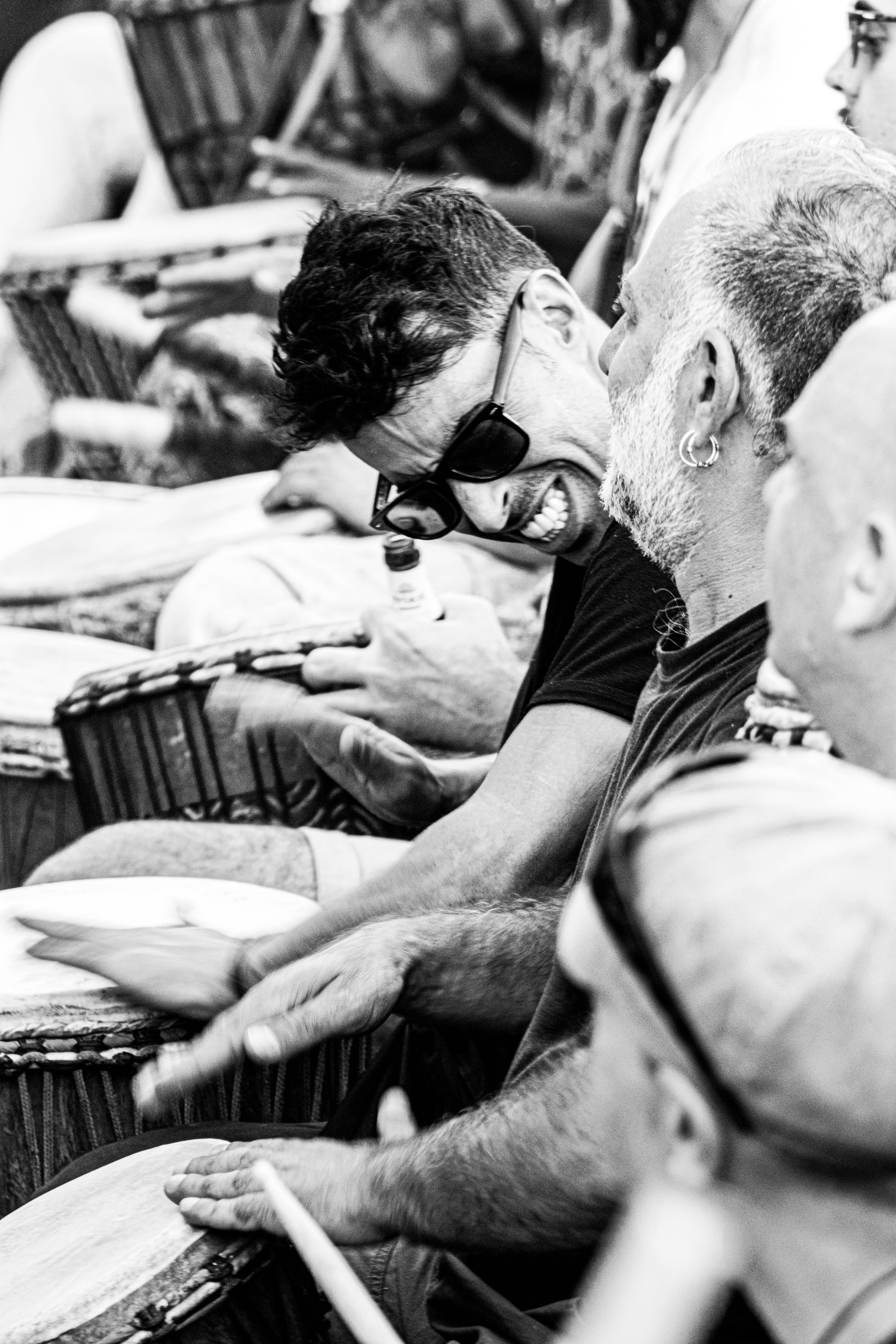 Community drumming scene representing nervous system regulation, embodiment, and holistic approaches to chronic pain care in Oak Park and Chicago.