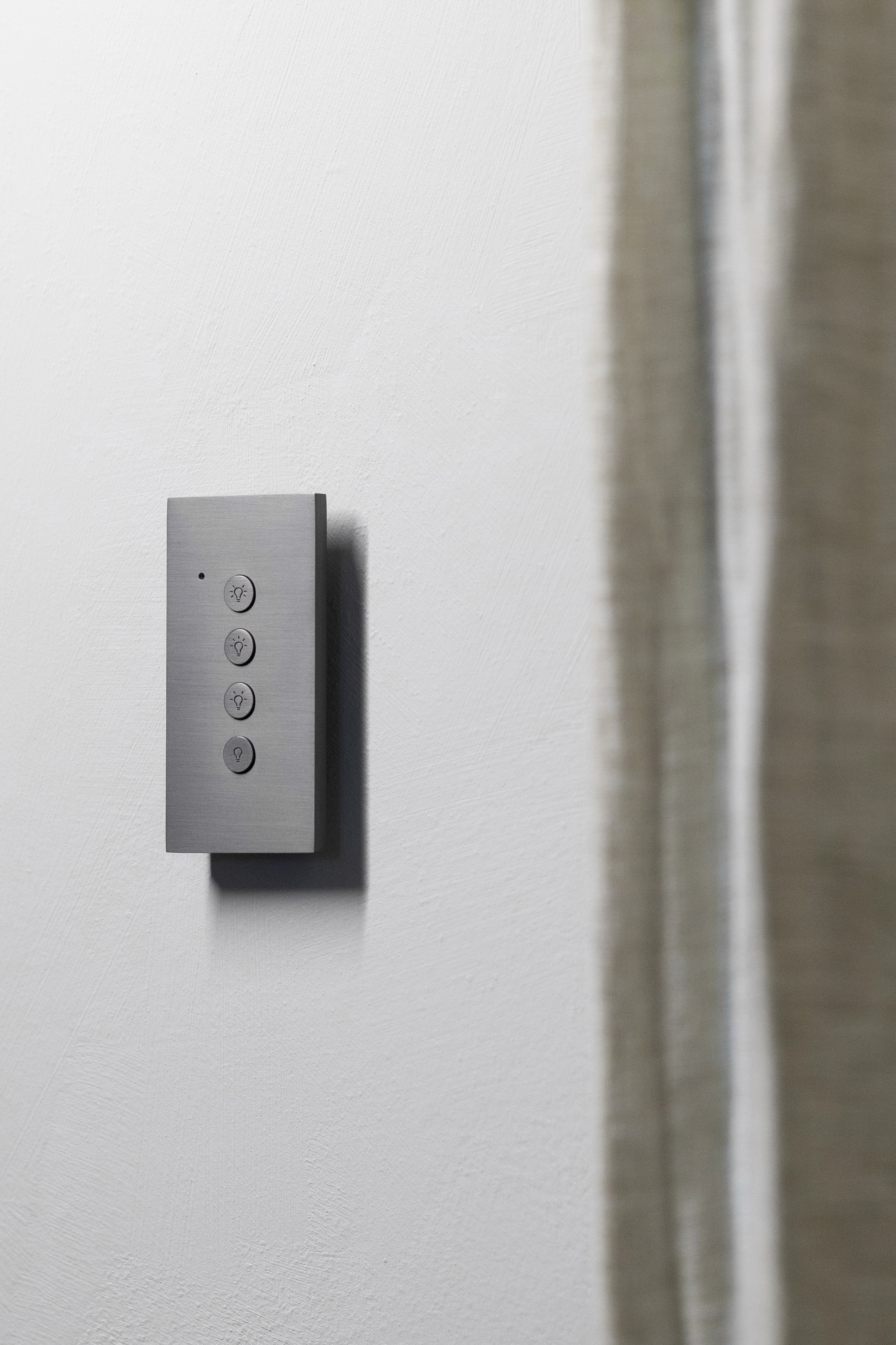 Modern light switch panel with four buttons.