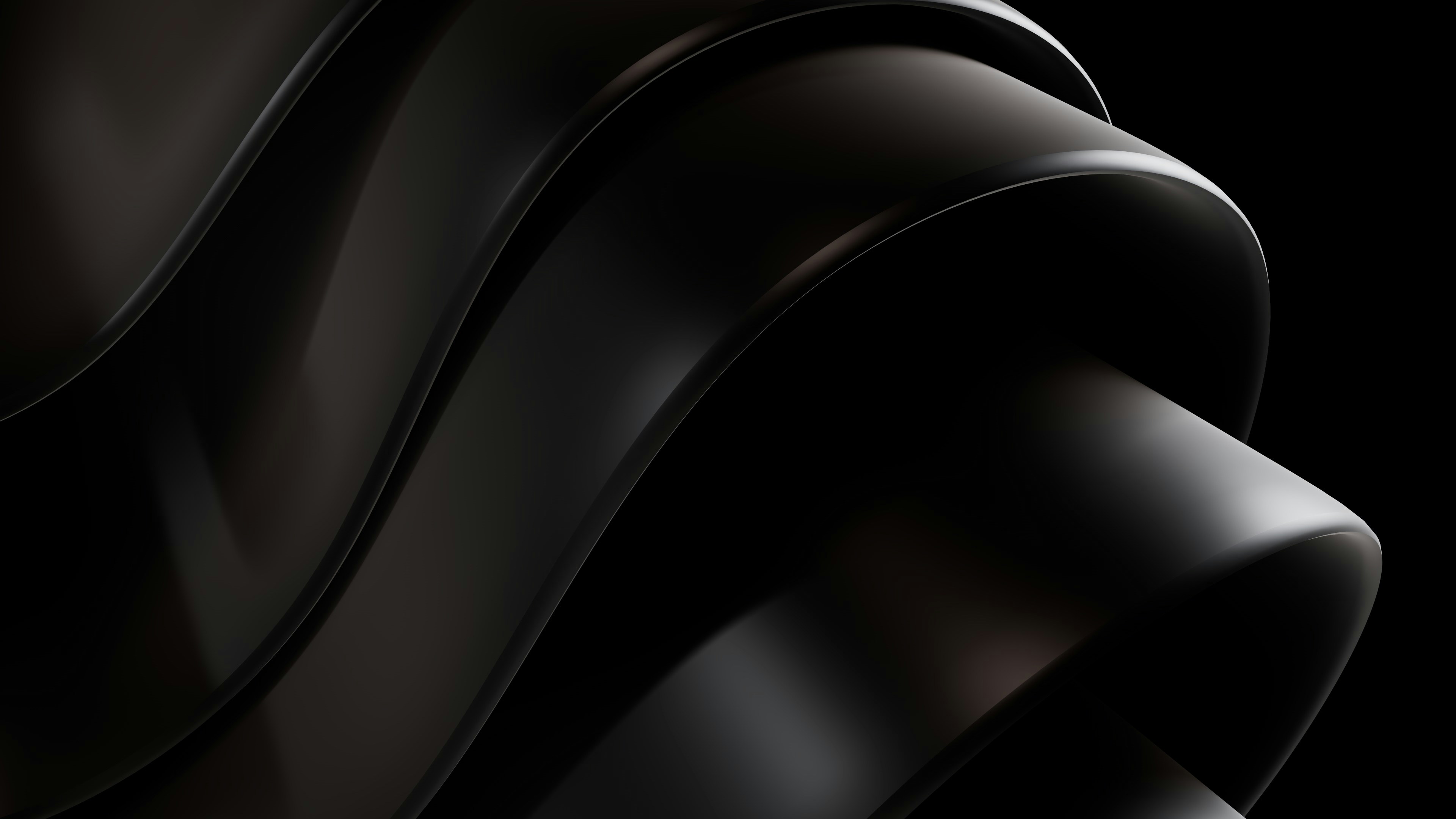 a close up of a black object with a black background