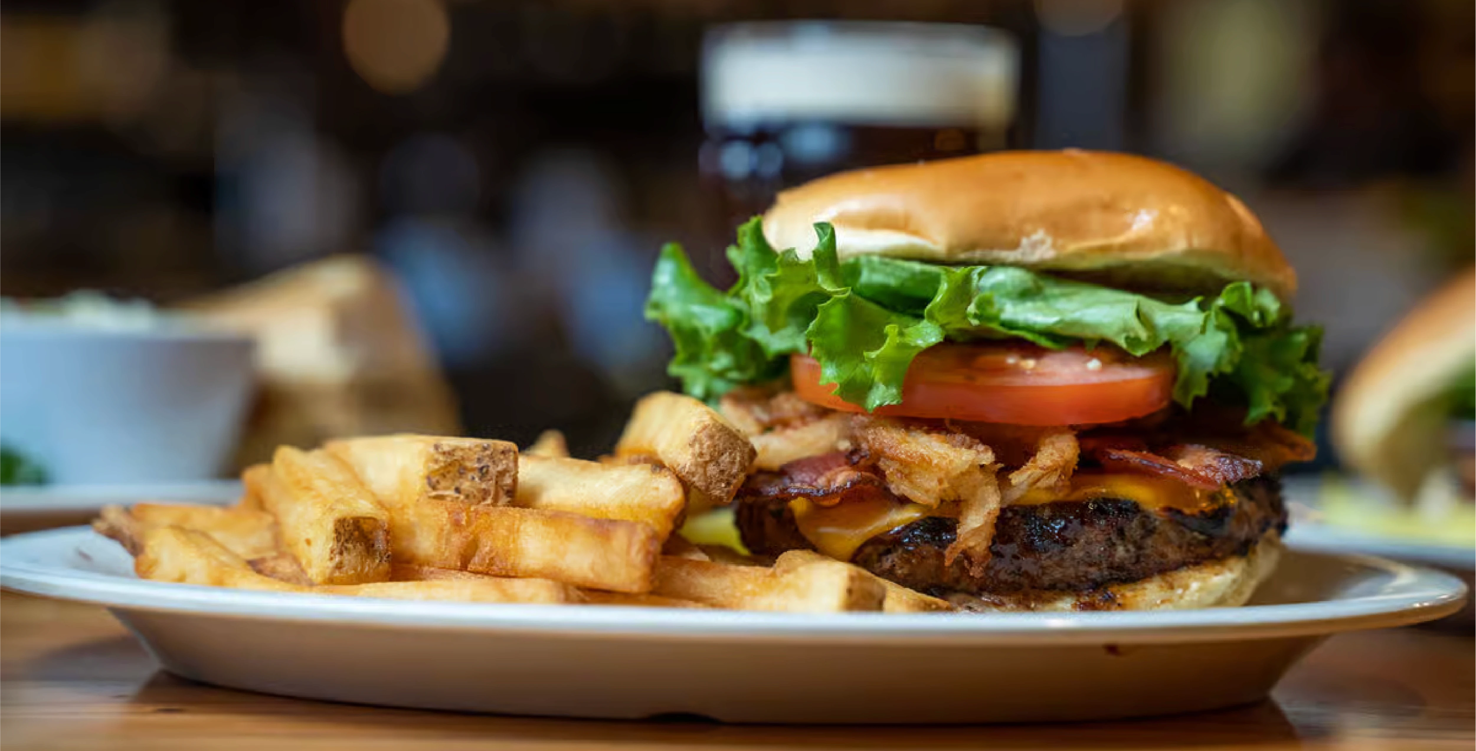 Close up of Burger and fries on a plate inside a bar