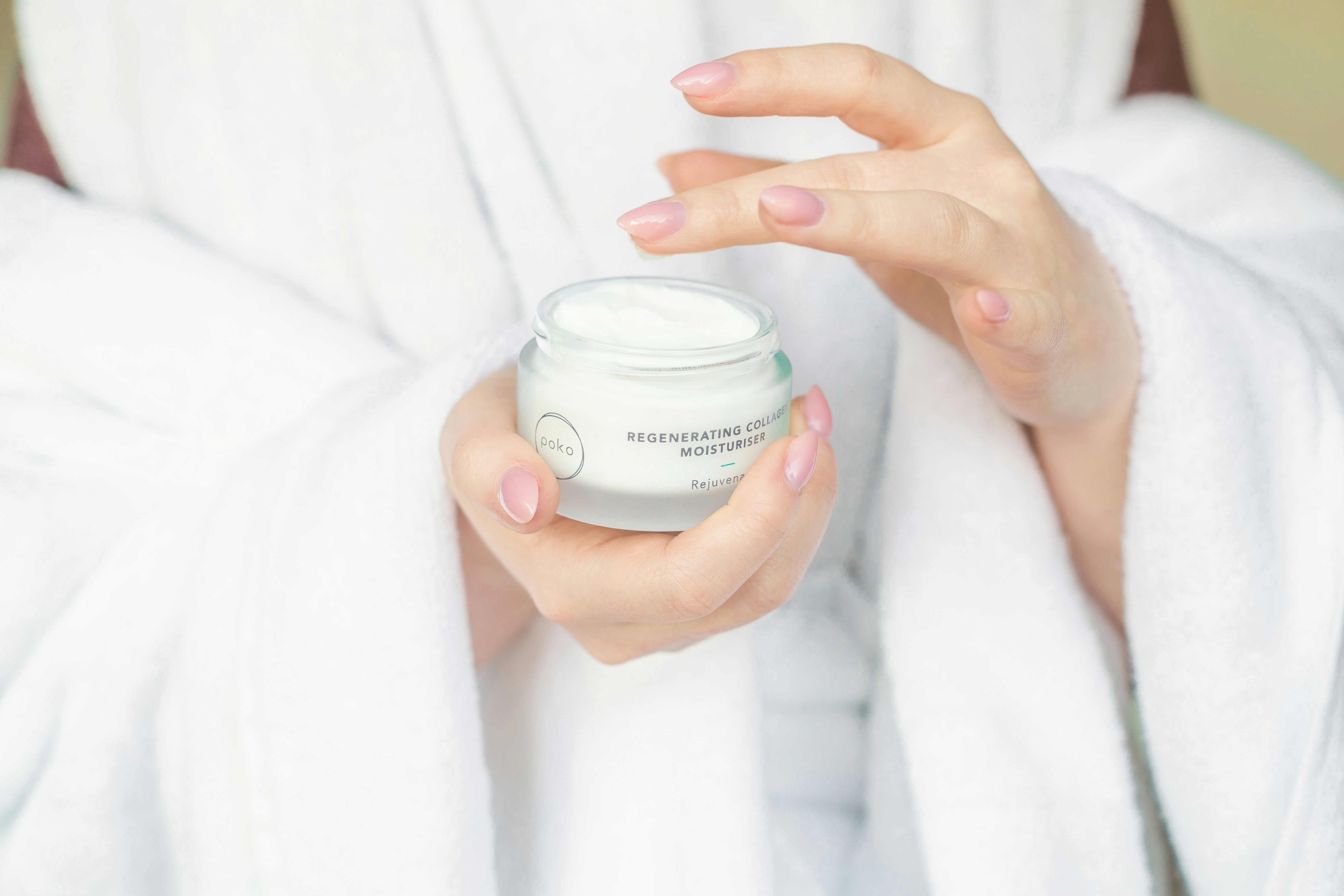 woman with cream in hand - best skincare brands