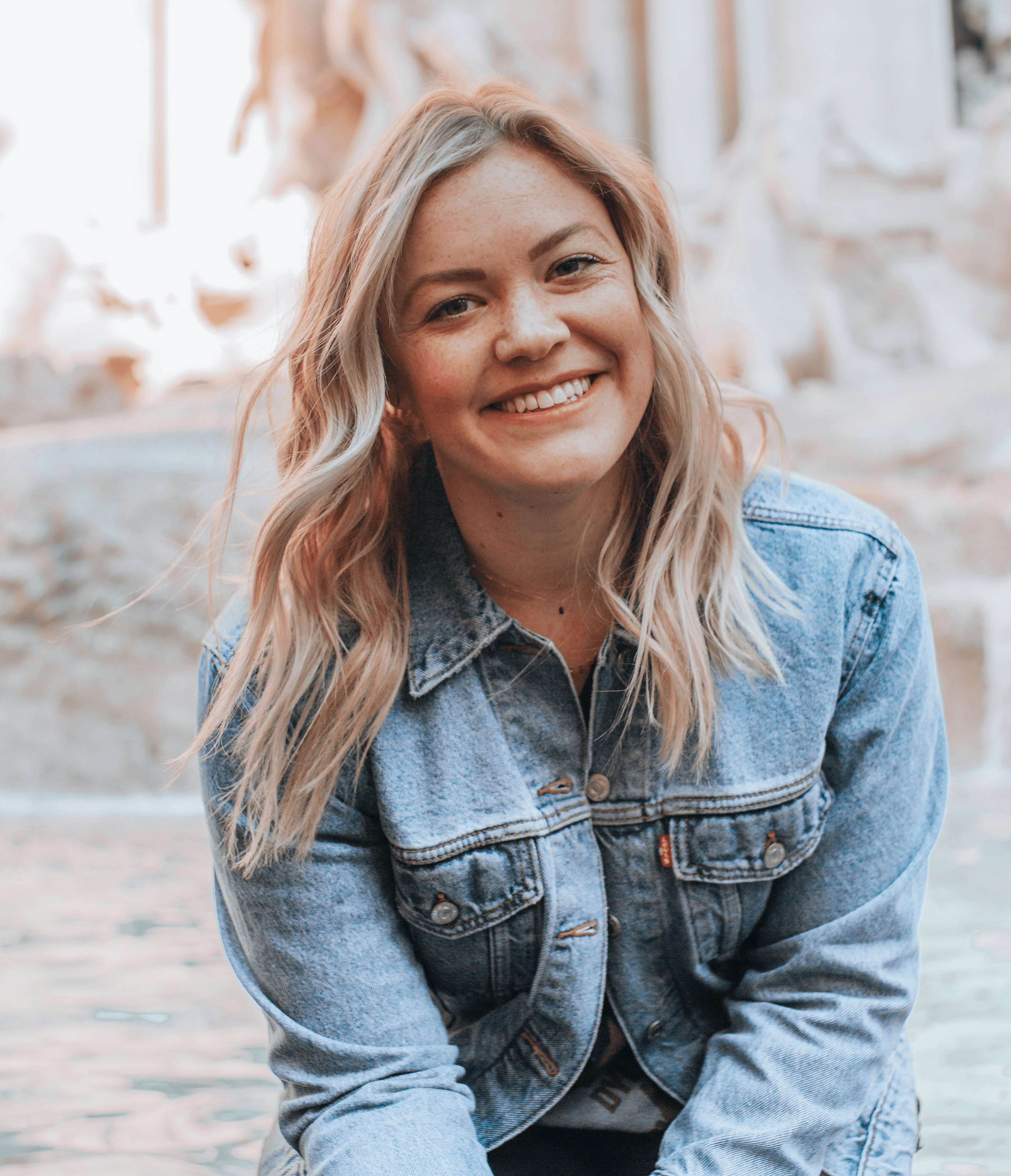 woman smiling wearing denim jacket