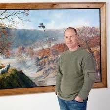A thoughtful young person with dark hair gazes to the side, captured in soft black and white lighting.