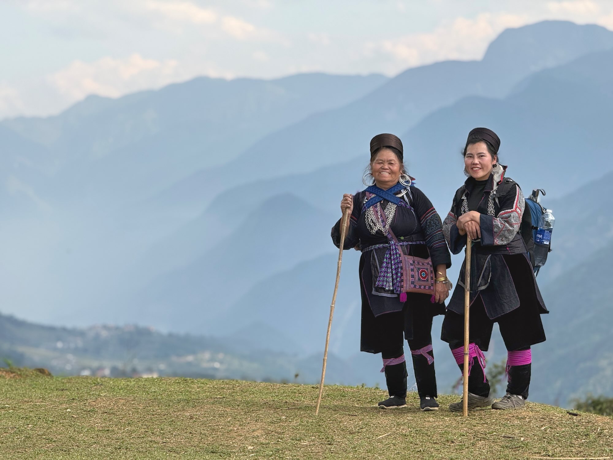 Black Hmong guides standing on a mountain viewpoint in Sapa Vietnam