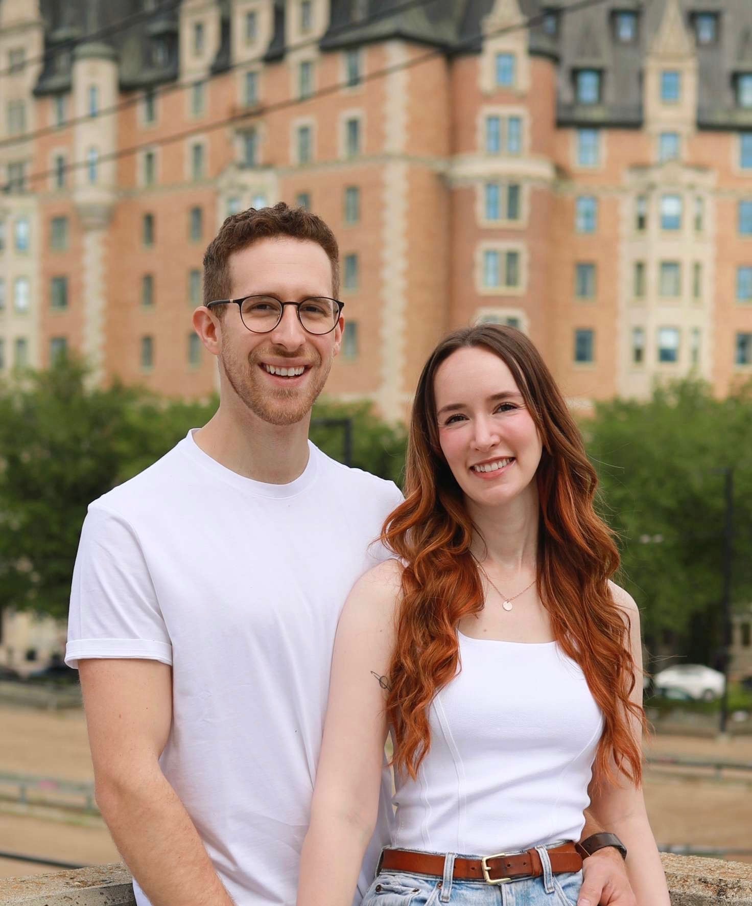 Tanner and Michaela, the owners of Oak & Ember, pictured in dowtown Saskatoon smiling at the viewer
