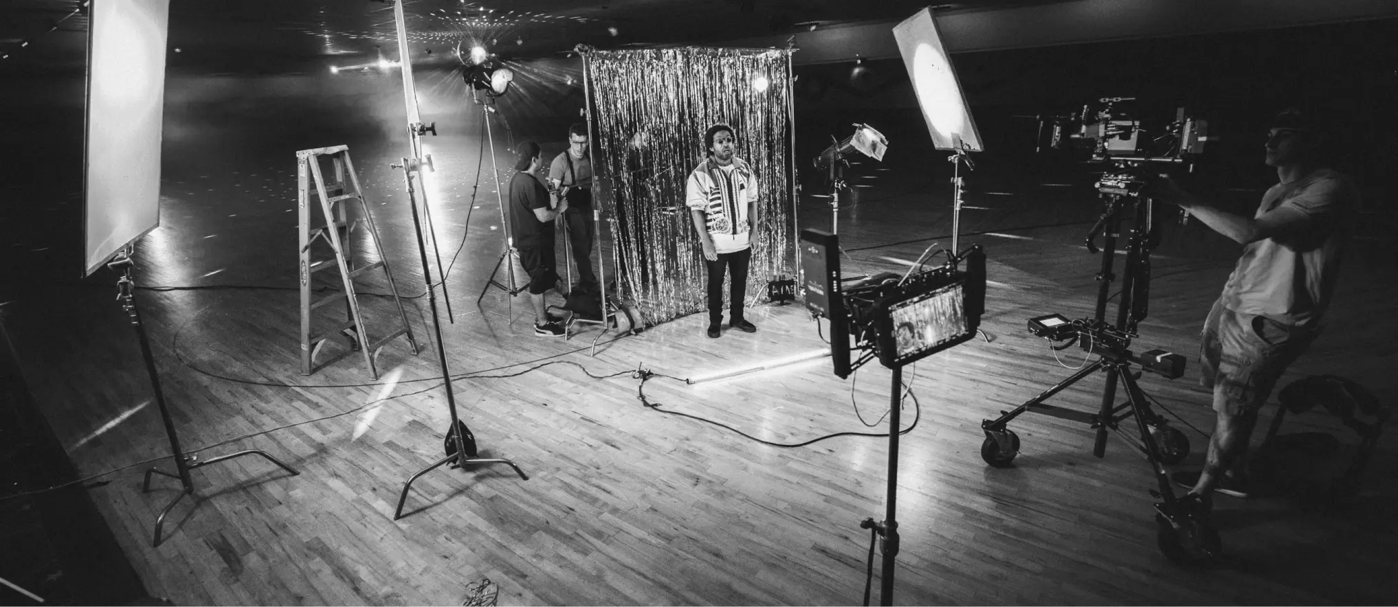 A video shoot for an advertisement showcasing a fashion brand with a musician performing.