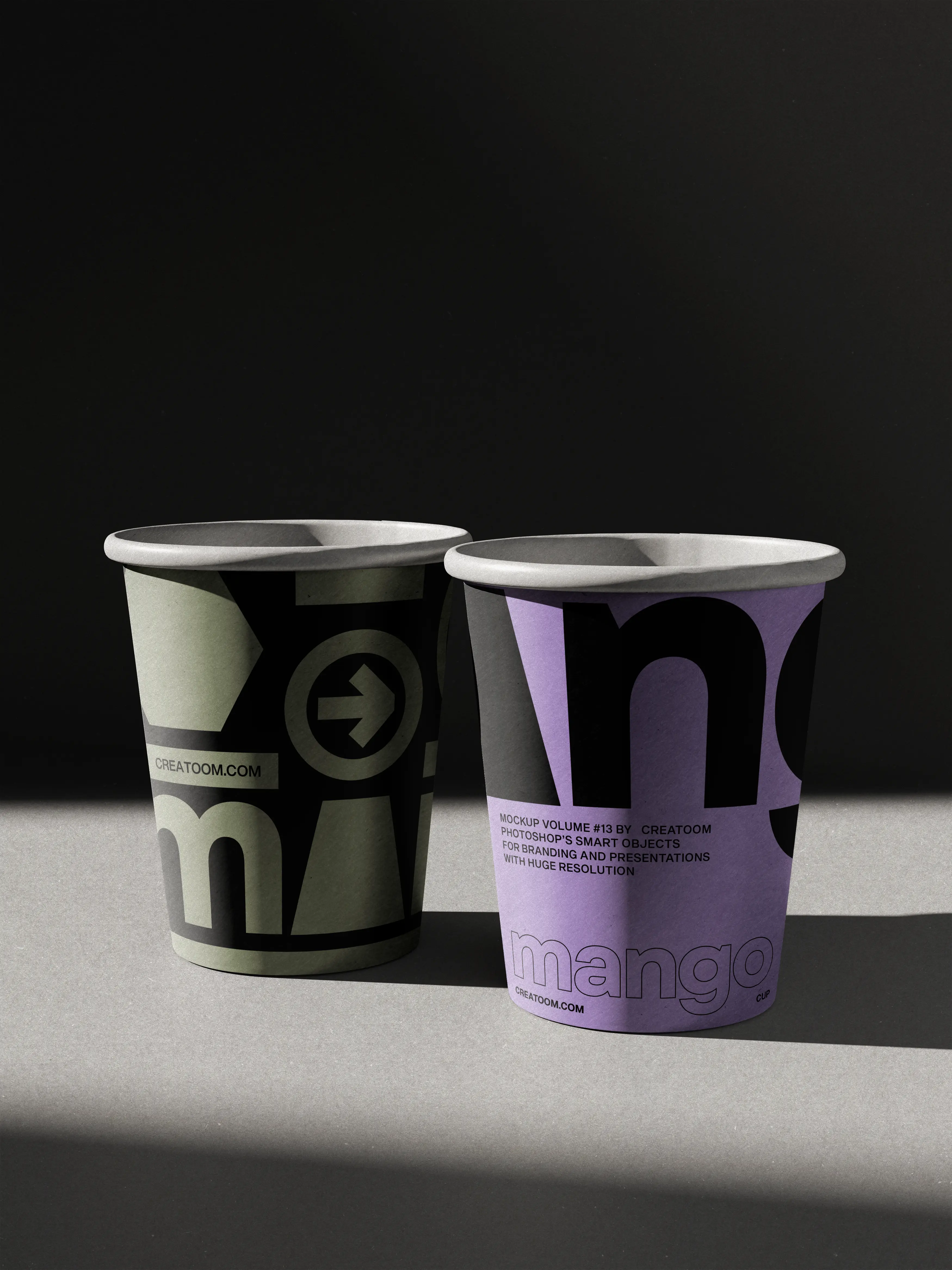 Two printed paper cups, olive and lilac, side by side under a hard light