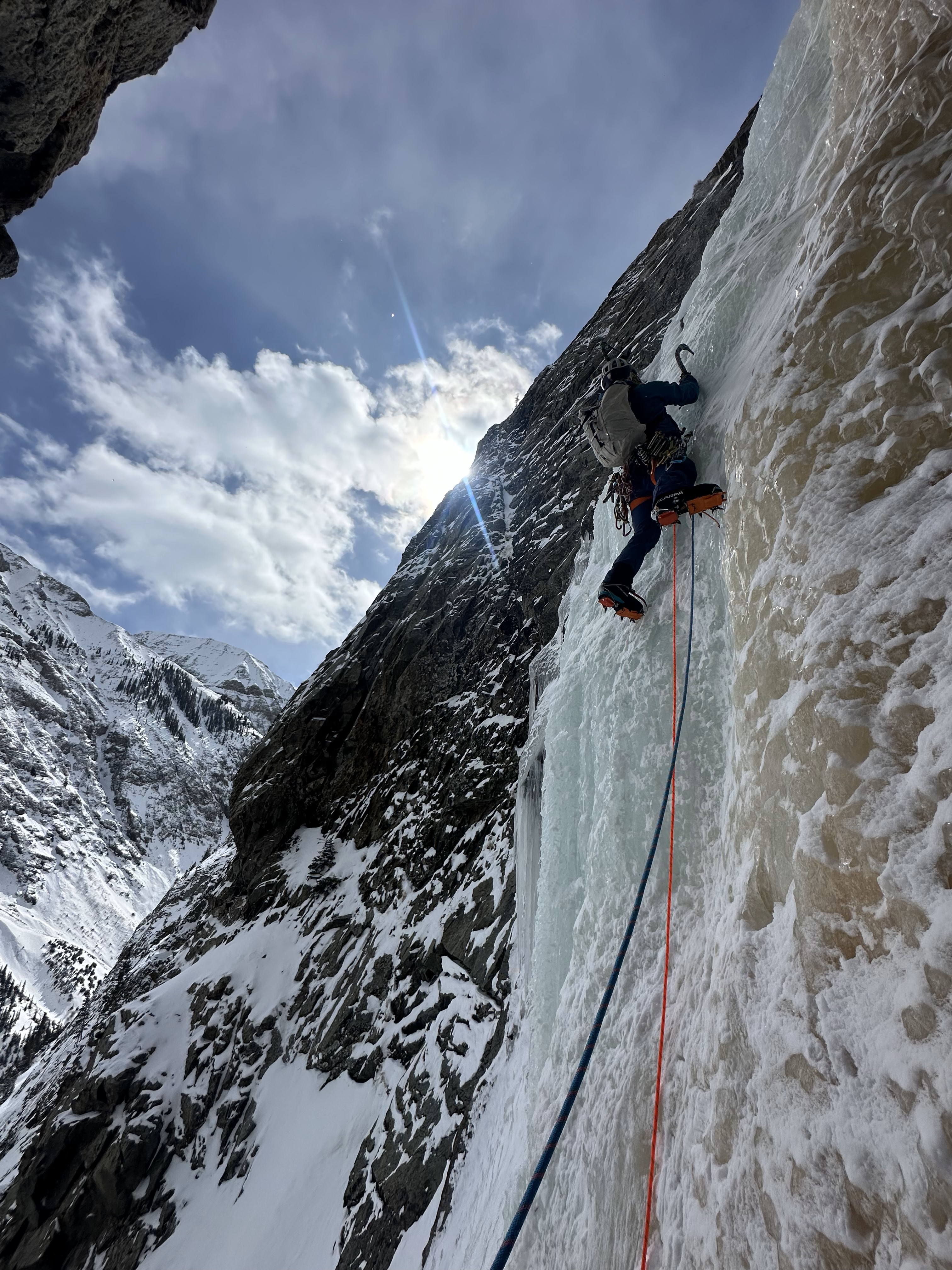 Ice climber leads steep slab of ice in Eureka