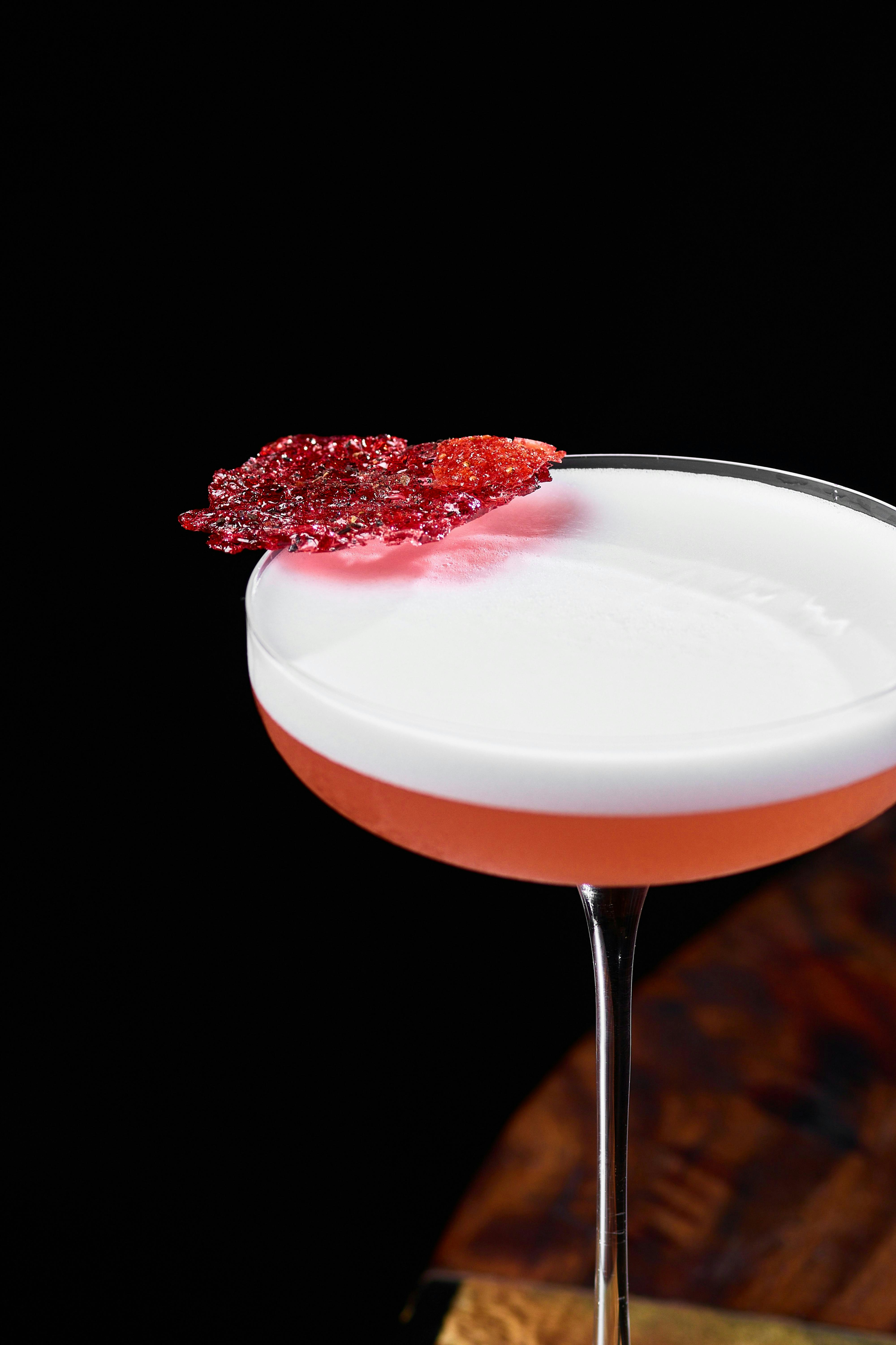 Elegant cocktail garnished with a decorative sugar piece.