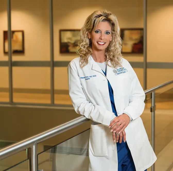 image of Sharona B. Ross, MD, FACS in a white doctor outfit leaning on a railing