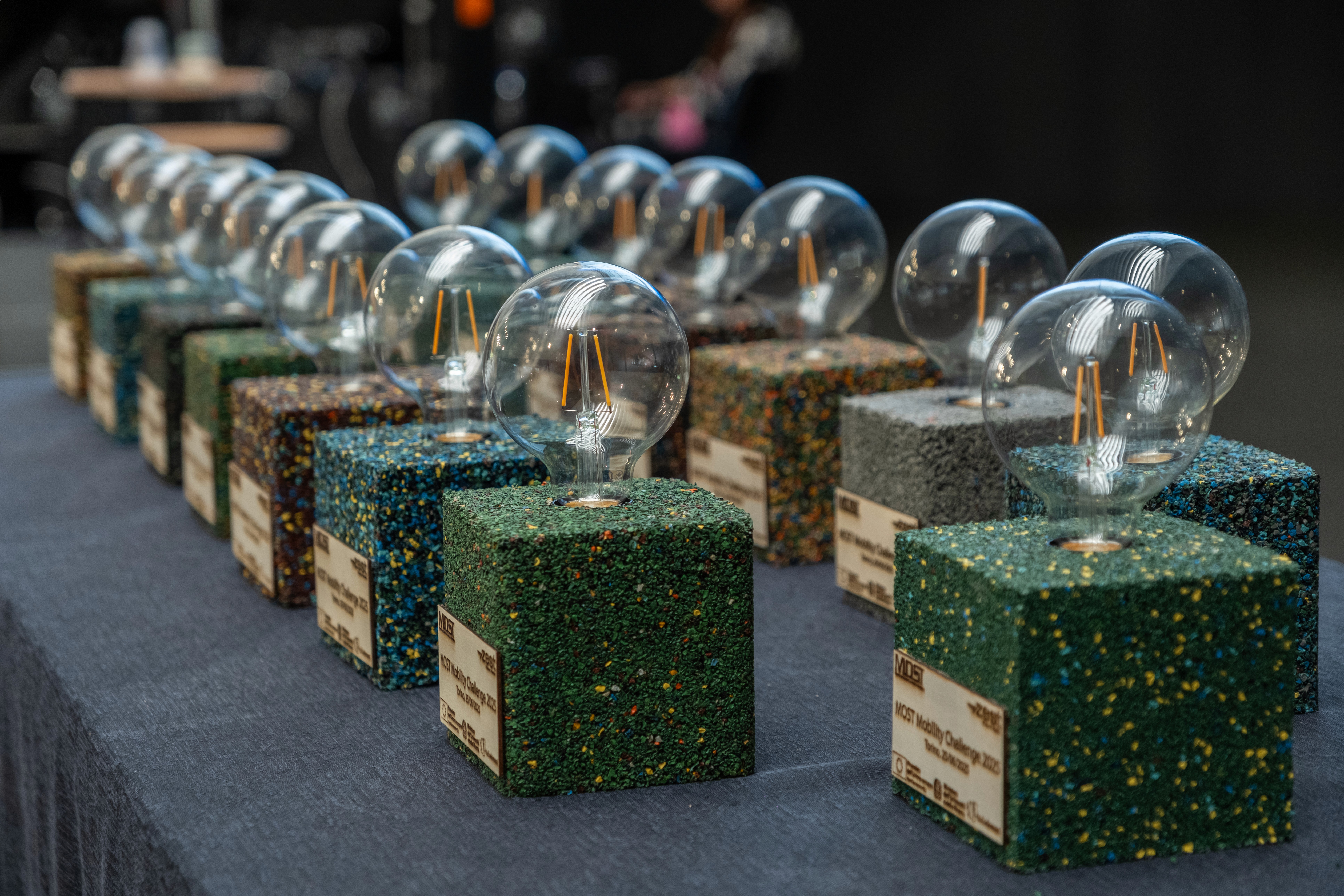 Wind turbine overlooking bright green farmland and scattered buildings