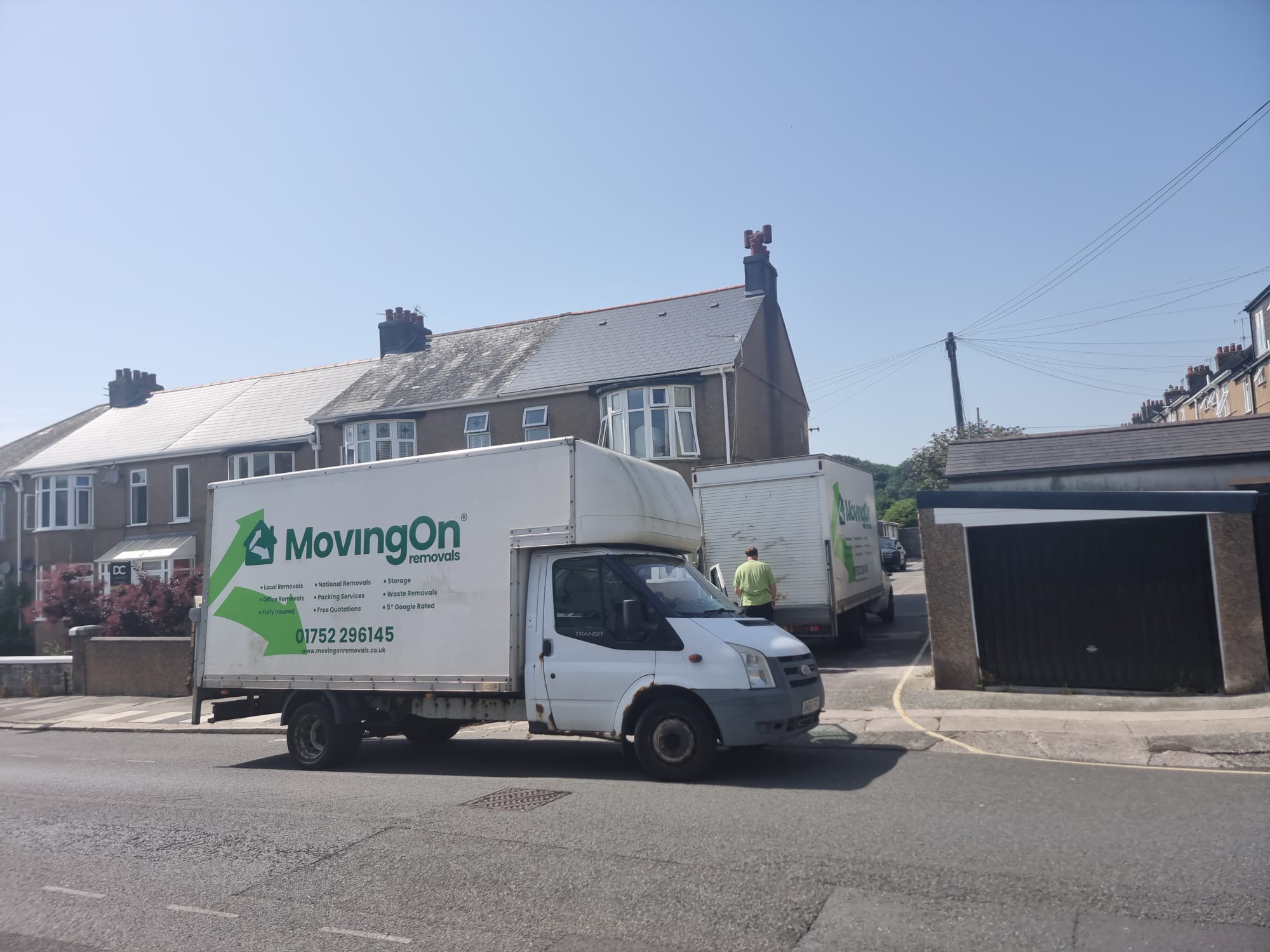 Two Moving On Removals vans parked on a residential street in Plymouth during a multi-stop house move to Mutley.