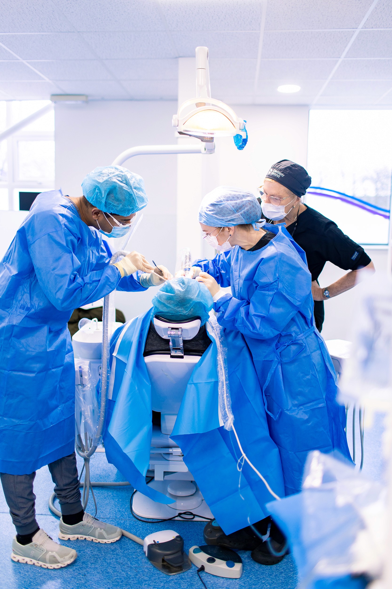 dentists on a dental training course discussing different aesthetic dentistry techniques.
