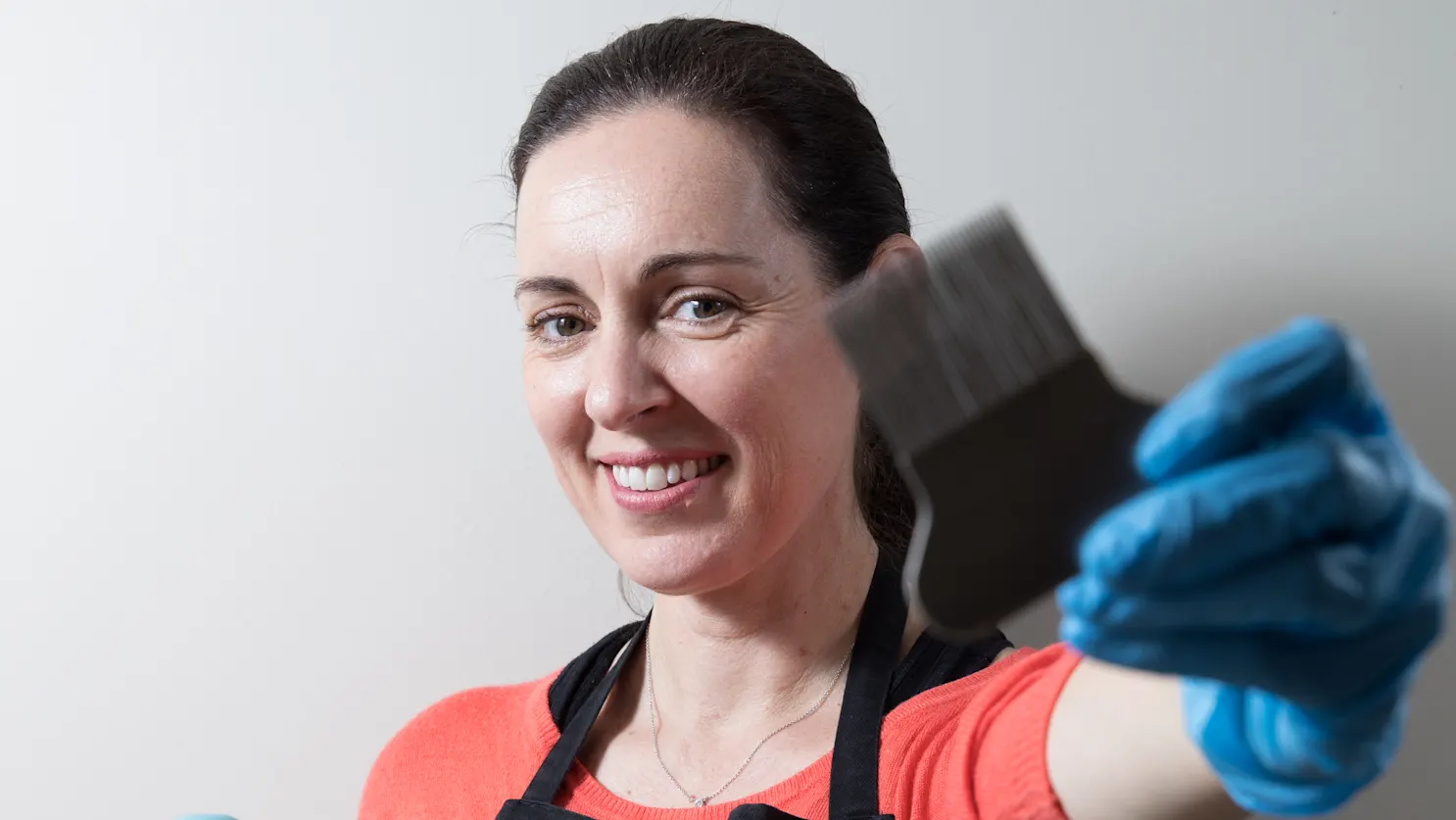 Deb Mcintyre, founder of No Nits, holding up a lice comb