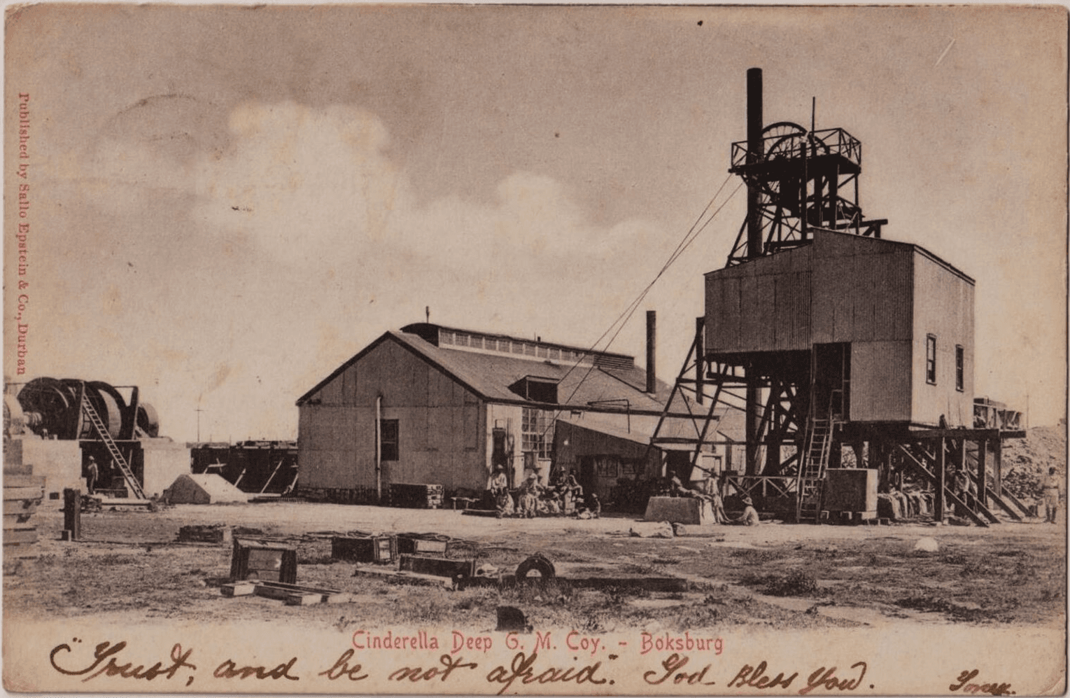 Historic postcard with an image of the Cinderella Deep Goldmine, Boksburg. Handwriting over the bottom edge reads "Trust, and be not afraid. God bless you." 