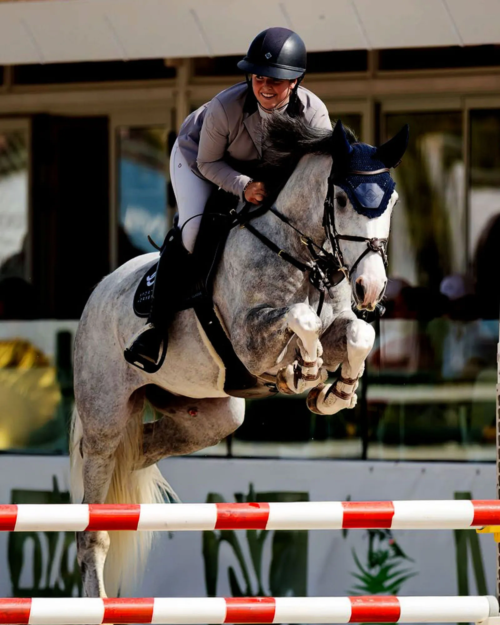 Horse and rider jumping over fence