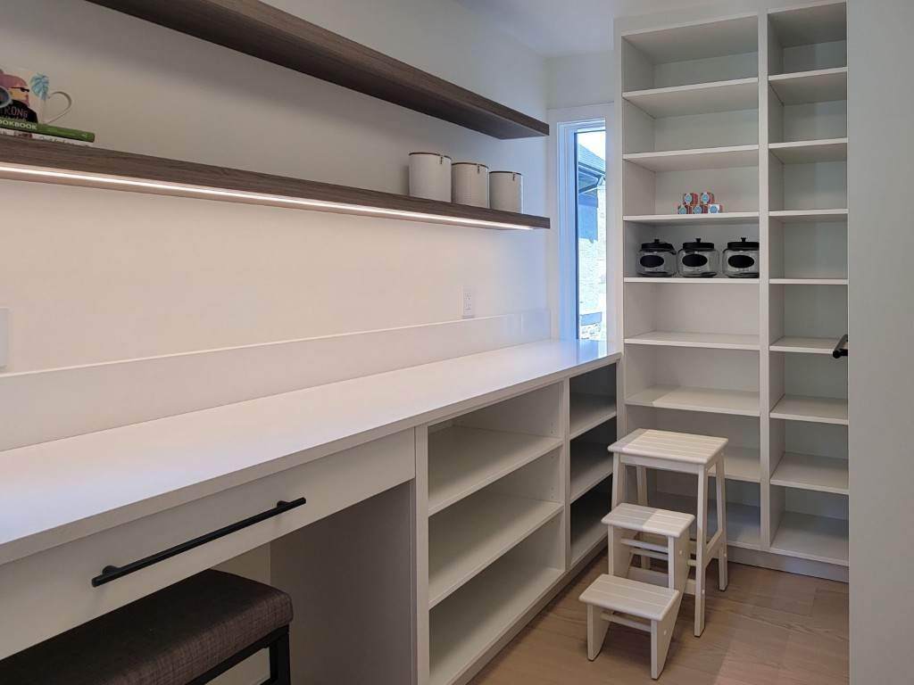 Image of Modern walk-in pantry with custom shelving, layout design, and furniture by KHD Homes interior design team.