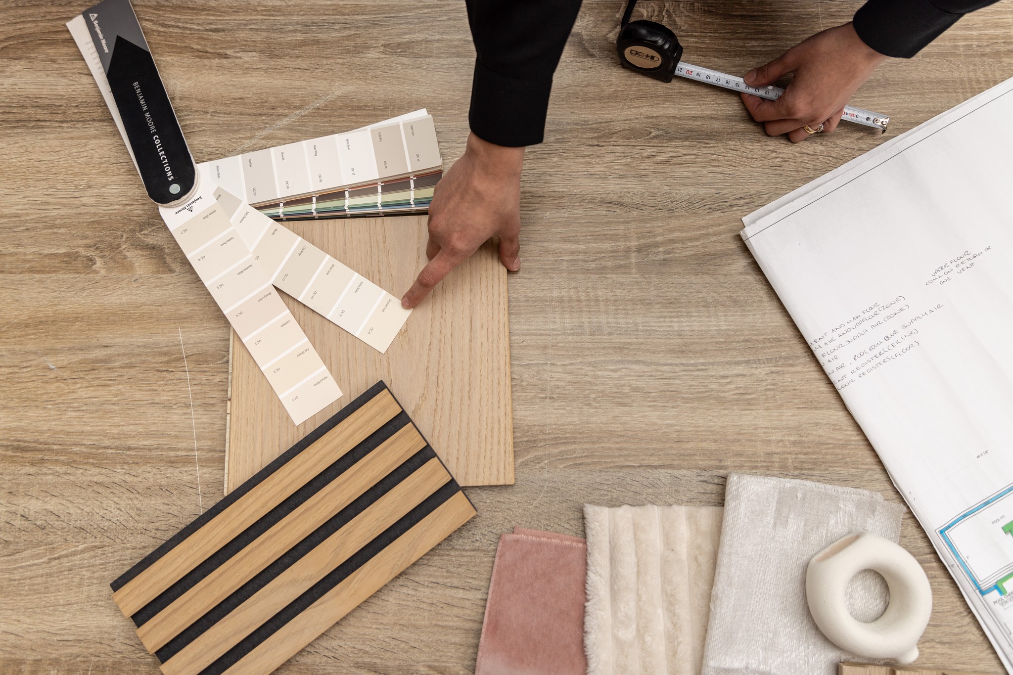 Image of KHD Homes design-build team selecting materials for home renovations including flooring, paint and fabrics.