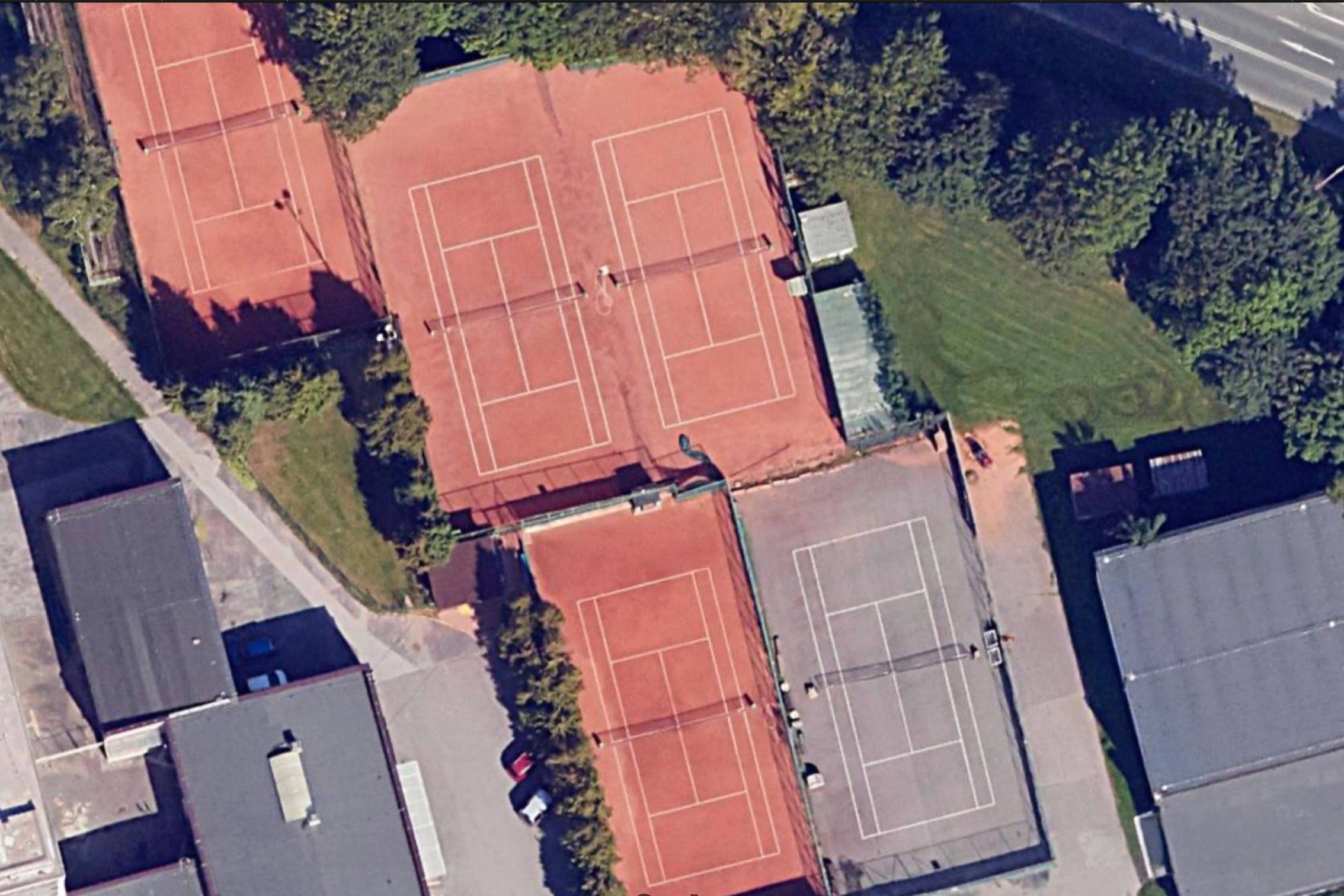 a tennis court with a blue floor and red seats
