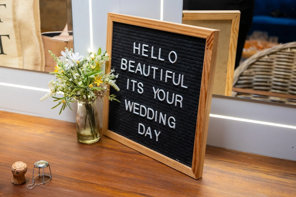 Wedding details sign reading “Hello beautiful, it’s your wedding day” at The Great Barn Aynho