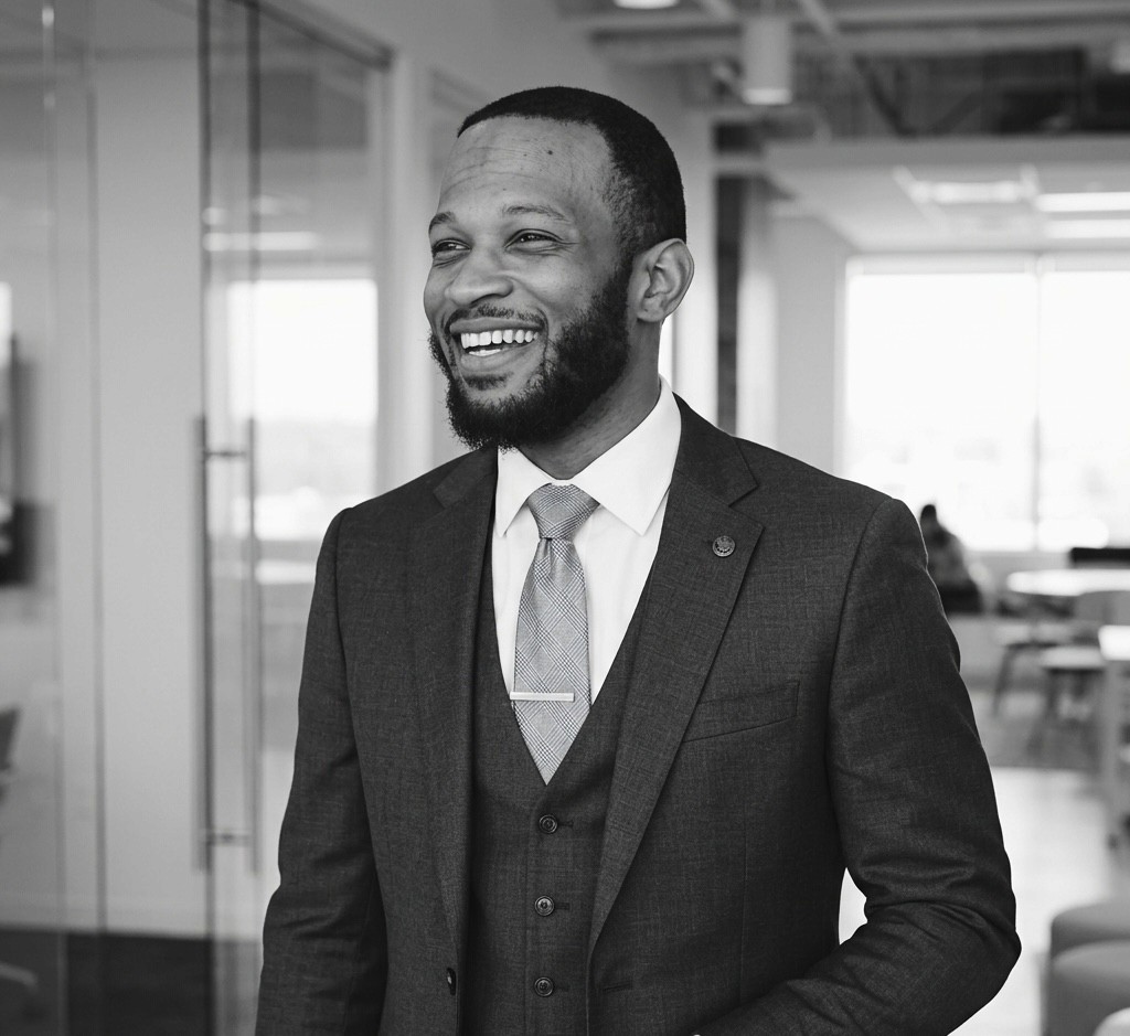 man in gray polo shirt smiling